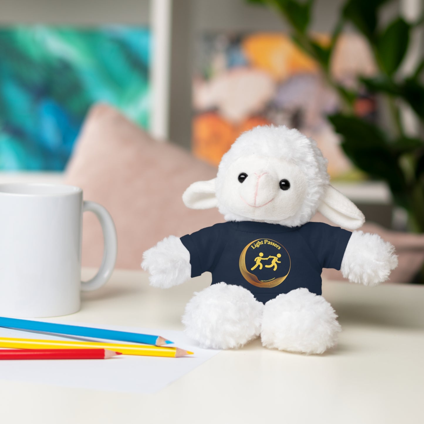 Cool Stuff Stuffies stuffed animal with Light Passers relay Logo on a T-shirt, sitting on a table, part of a customizable plush toy collection.