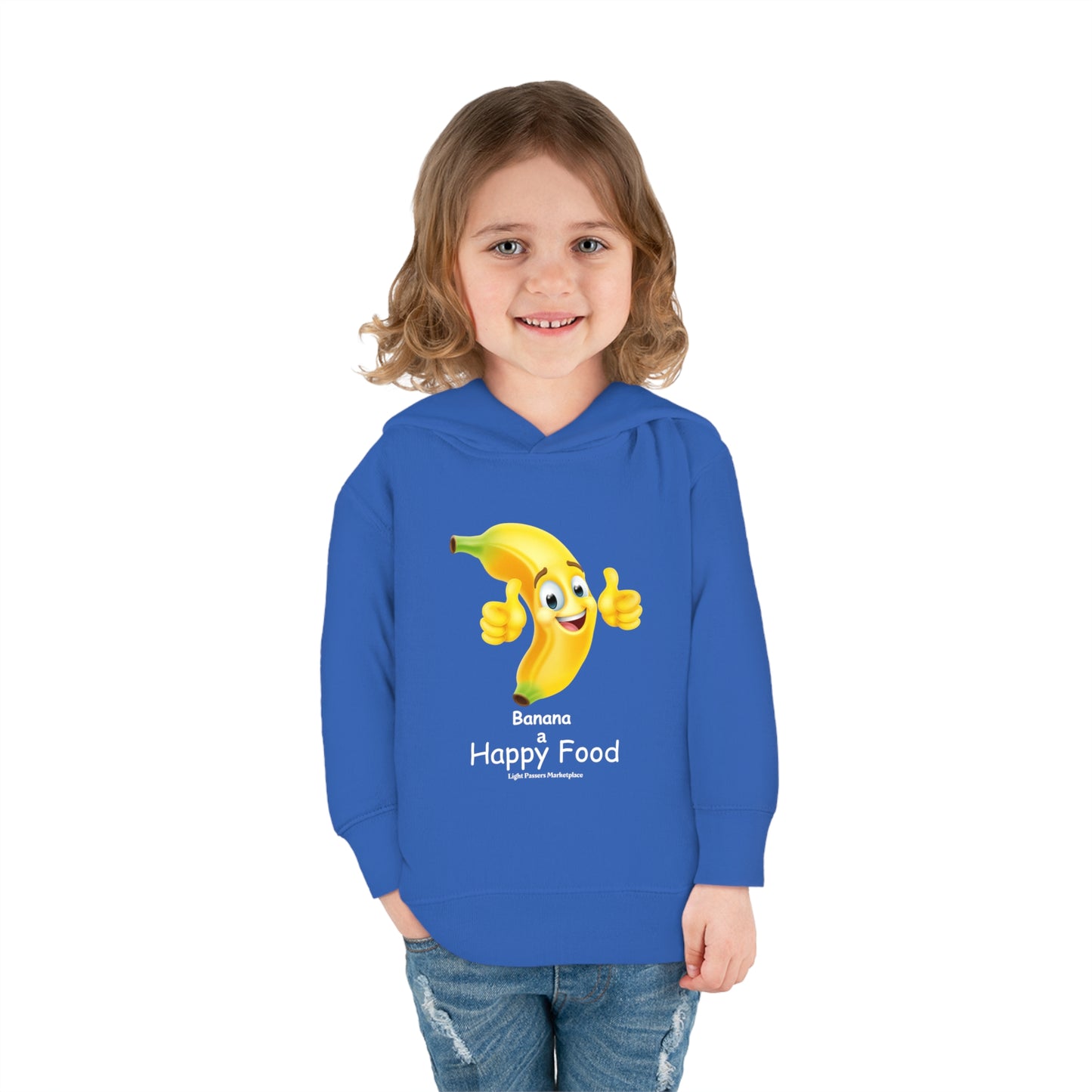 A child in a blue Banana Happy Food Toddler Hooded Sweatshirt smiles, showing a cartoon banana. Features jersey-lined hood, cover-stitched details, side seam pockets for cozy durability.