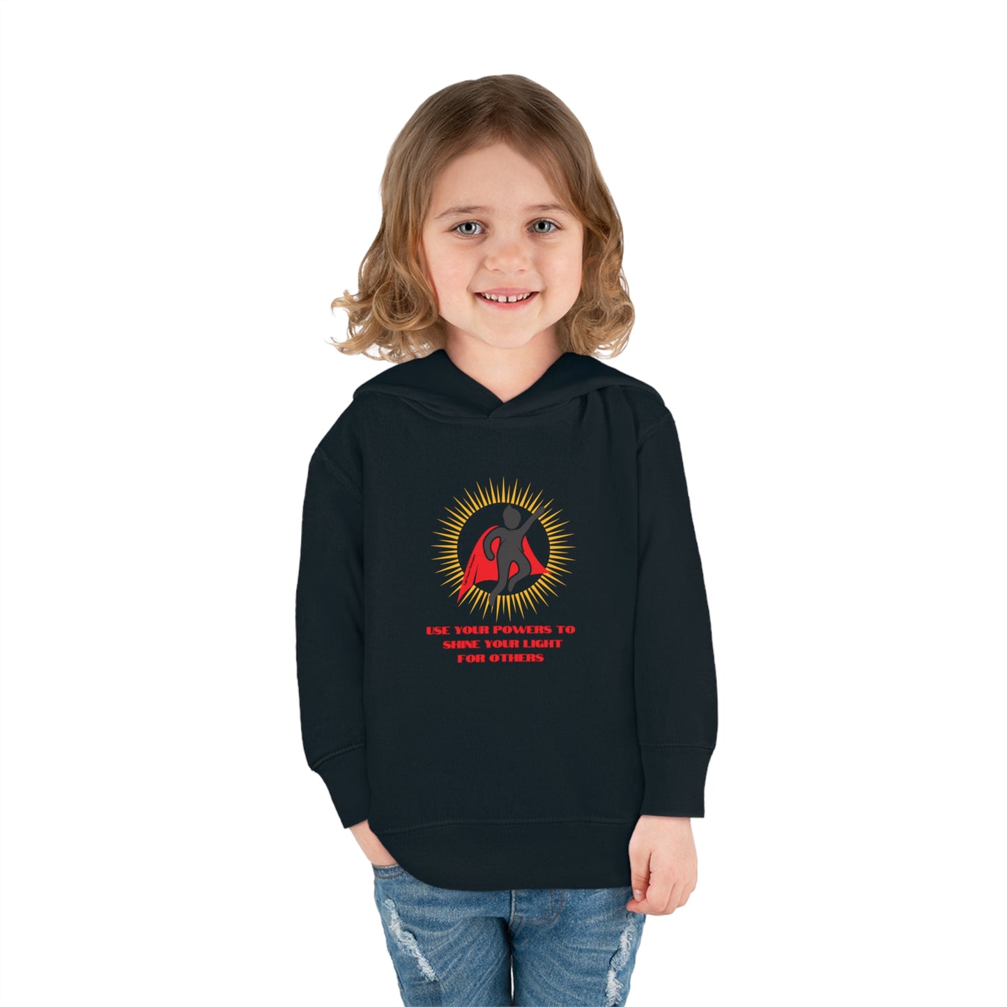 A smiling child in a black Rabbit Skins toddler hoodie with logo, showcasing comfort and durability. Features jersey-lined hood, cover-stitched details, side pockets for cozy wear.