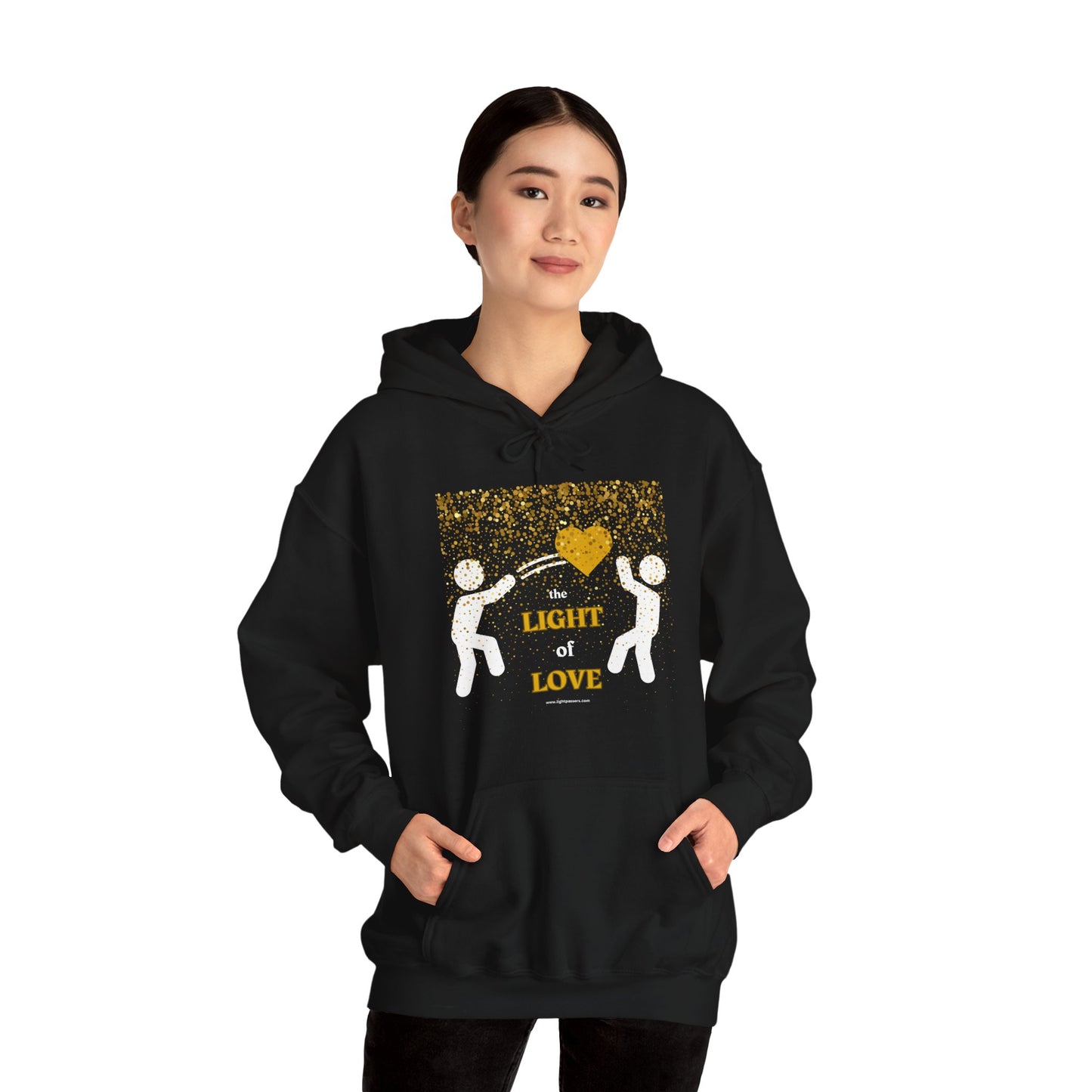A person in a black hoodie with a gold heart design, showcasing a cozy blend of cotton and polyester for warmth and comfort. Kangaroo pocket and color-matched drawstring add practicality and style.