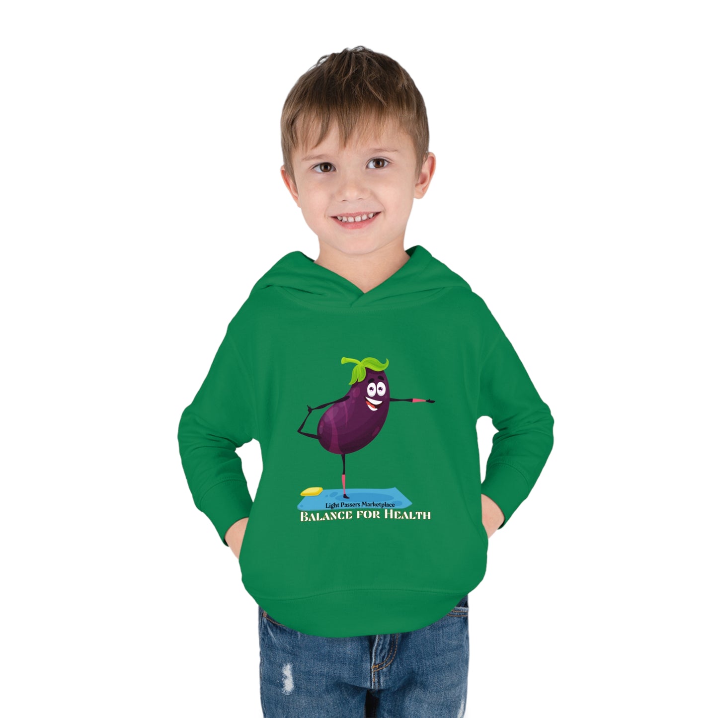 A toddler in a green hoodie with a cartoon eggplant design, showcasing side seam pockets and durable construction for lasting coziness.