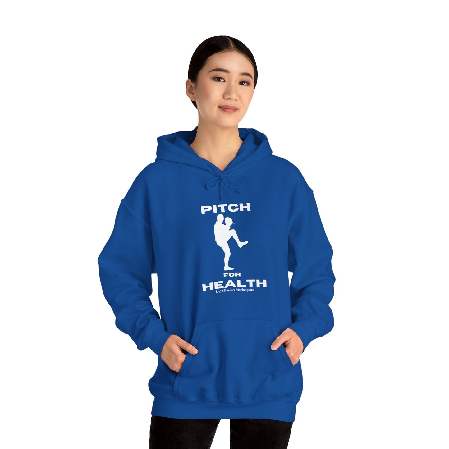 A woman in a blue hooded sweatshirt with a baseball player design, showcasing the Pitch For Health Unisex Hooded Sweatshirt's cozy cotton-polyester blend, kangaroo pocket, and color-matched drawstring for style and warmth.