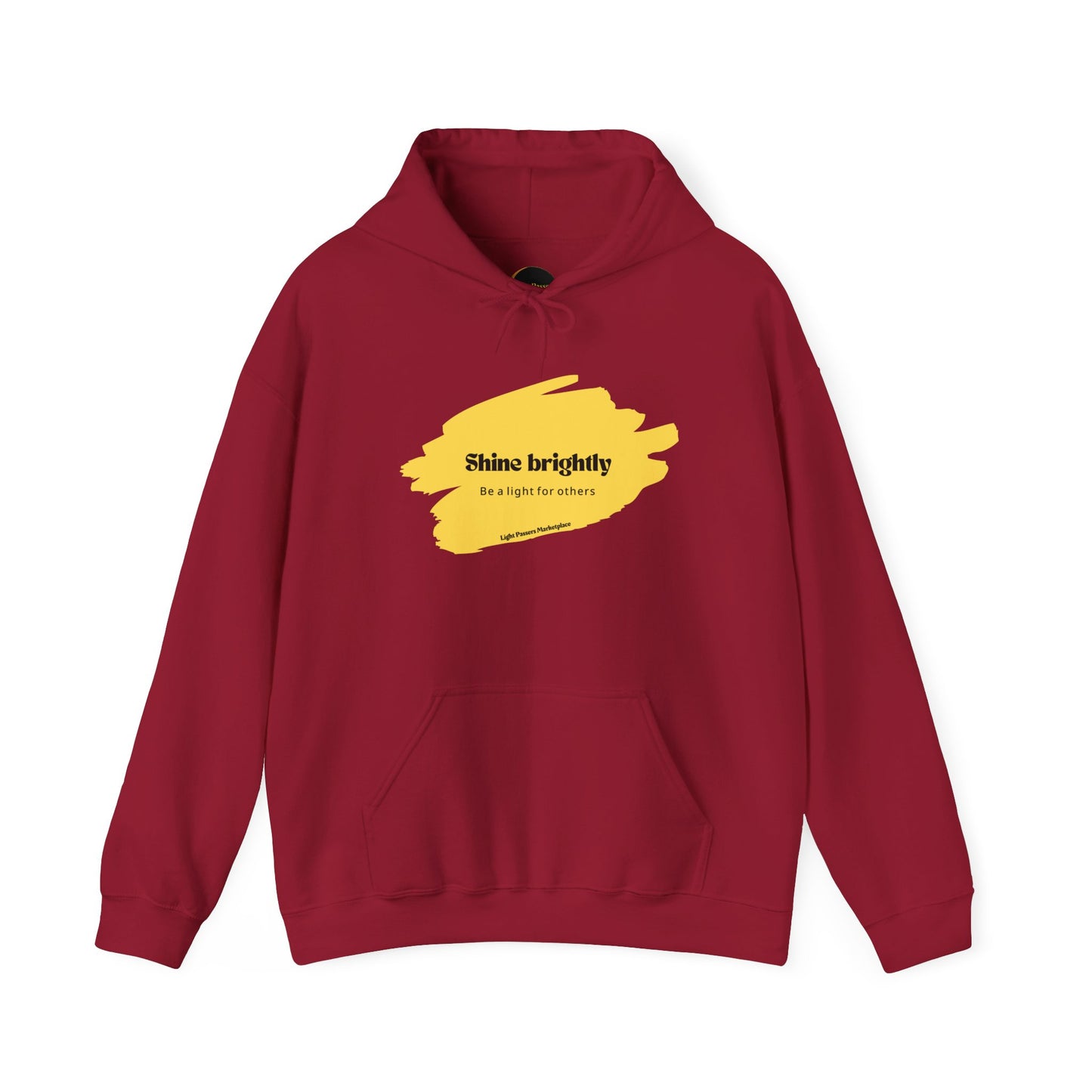 The Light Inspirational Hoodie - Shine Brightly Adult Unisex Heavy Blend™ Sweatshirt featuring a unique yellow paint splash design and cozy hooded style.
