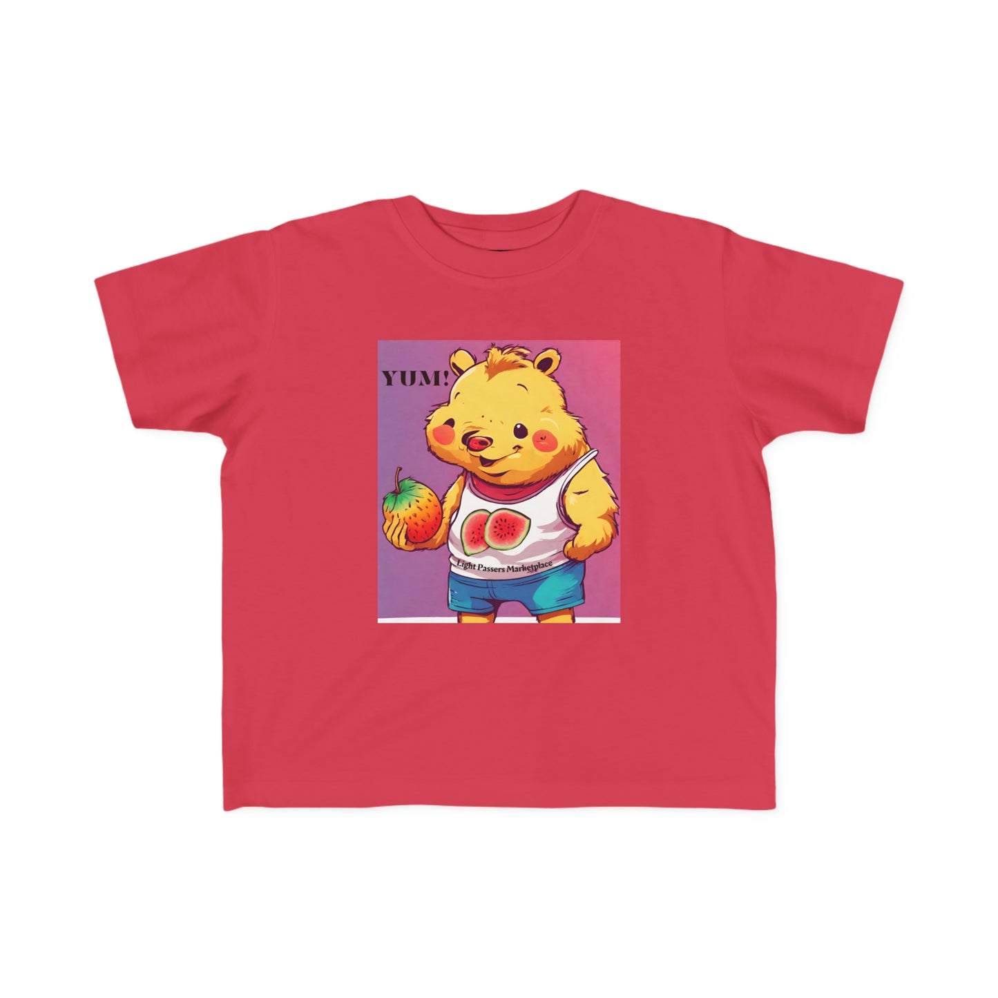 A toddler's tee featuring a cartoon bear holding a fruit, ideal for sensitive skin. Made of 100% combed cotton, light fabric, and a durable print.