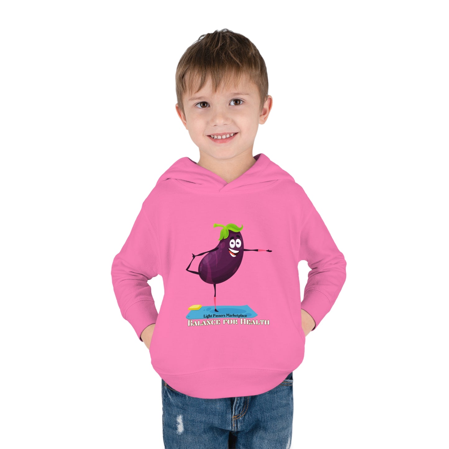 A toddler in a pink hoodie smiles, showcasing the Rabbit Skins Eggplant Balance for Health design. Jersey-lined hood, side pockets, and durable stitching ensure cozy comfort in this 60% cotton, 40% polyester hoodie.