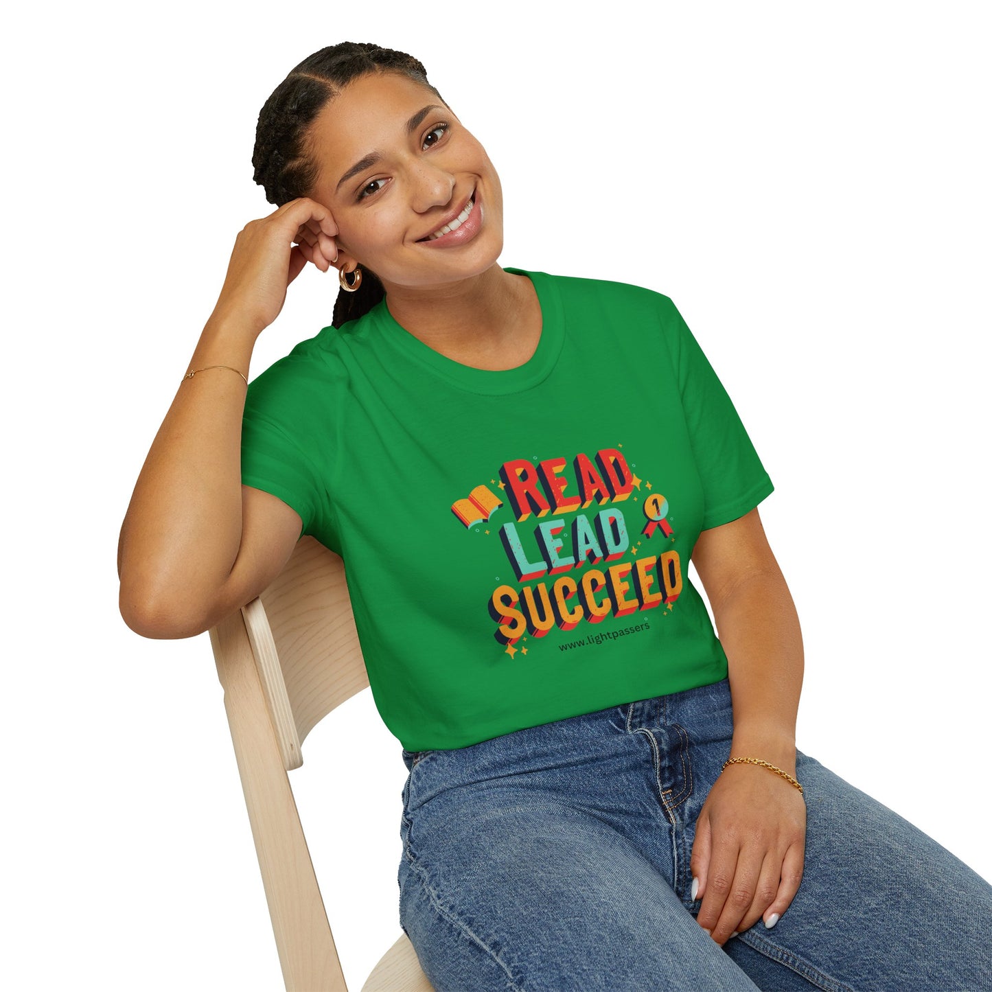 A woman in a green shirt sits on a chair, showcasing the Read Lead Succeed Unisex T-Shirt. Soft 100% cotton, twill tape shoulders, no side seams, ribbed collar.