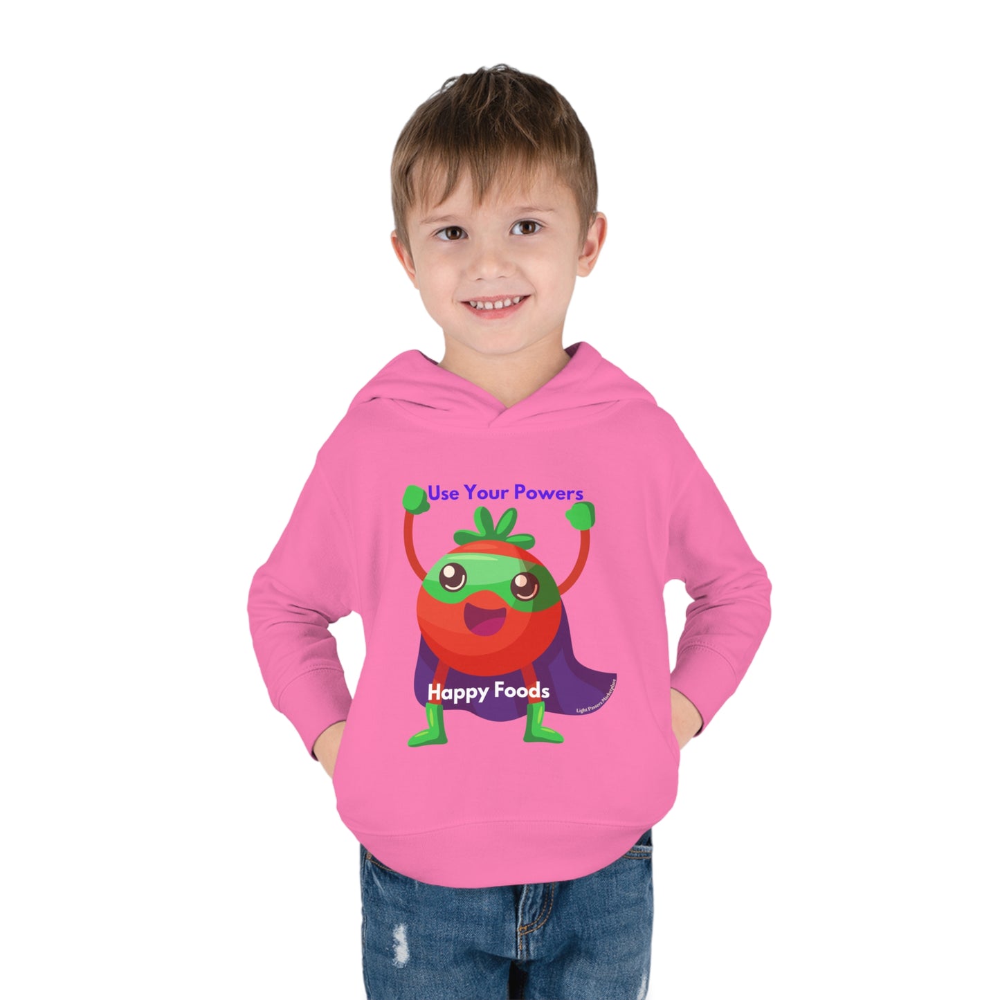 A toddler boy in a Tomato Power Toddler Hoodie with a cartoon character design, showcasing a jersey-lined hood, cover-stitched details, and side seam pockets for comfort and durability.