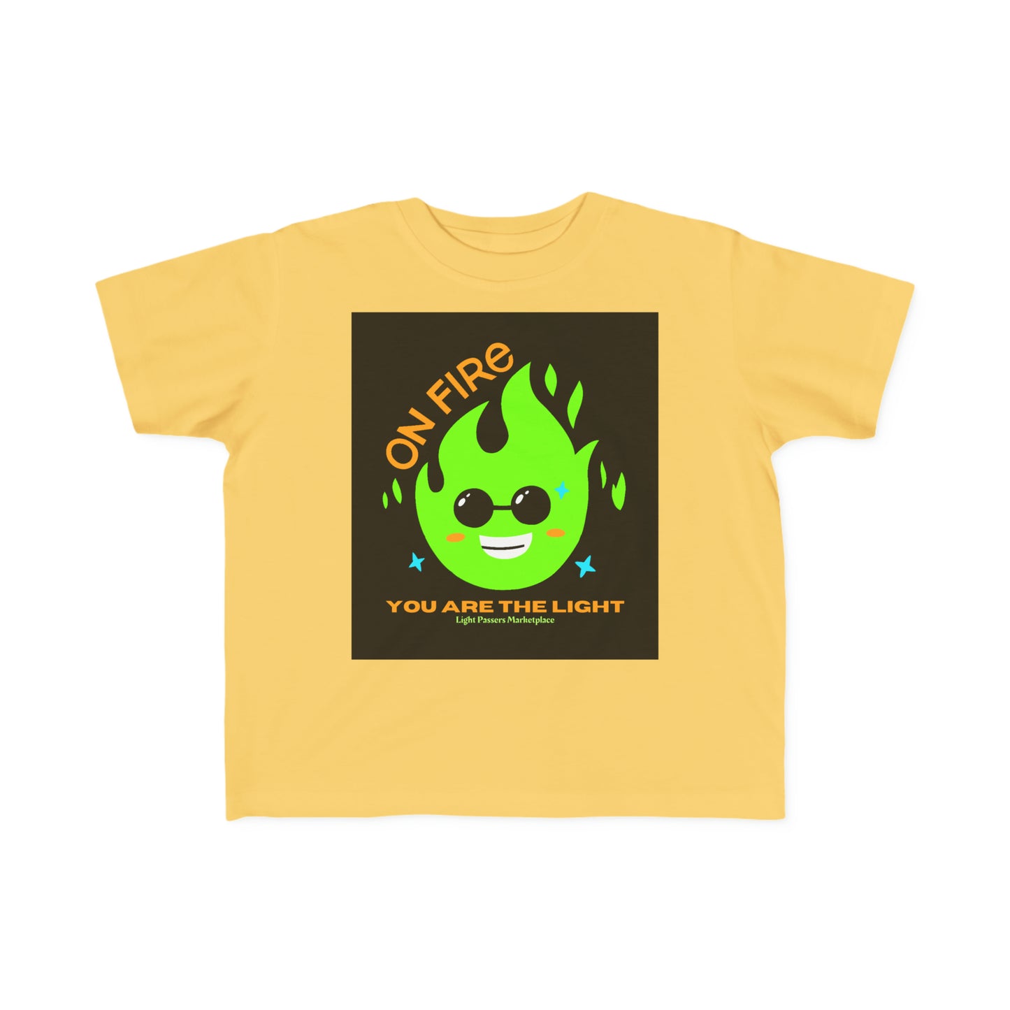 A toddler's tee featuring a yellow shirt with a green cartoon character wearing sunglasses and a black square with text. Soft and durable, perfect for sensitive skin.