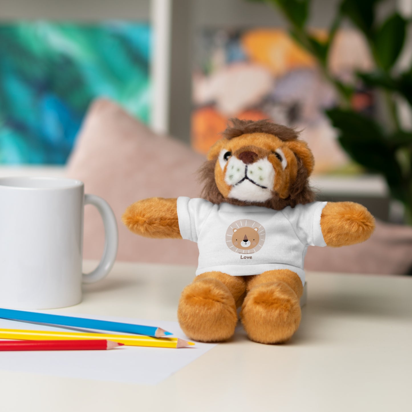 Plush Lion Stuffie wearing a shirt with a Lion Head, perfect cuddle toy for ages 3+, 8 tall, made of soft cotton and polyester.