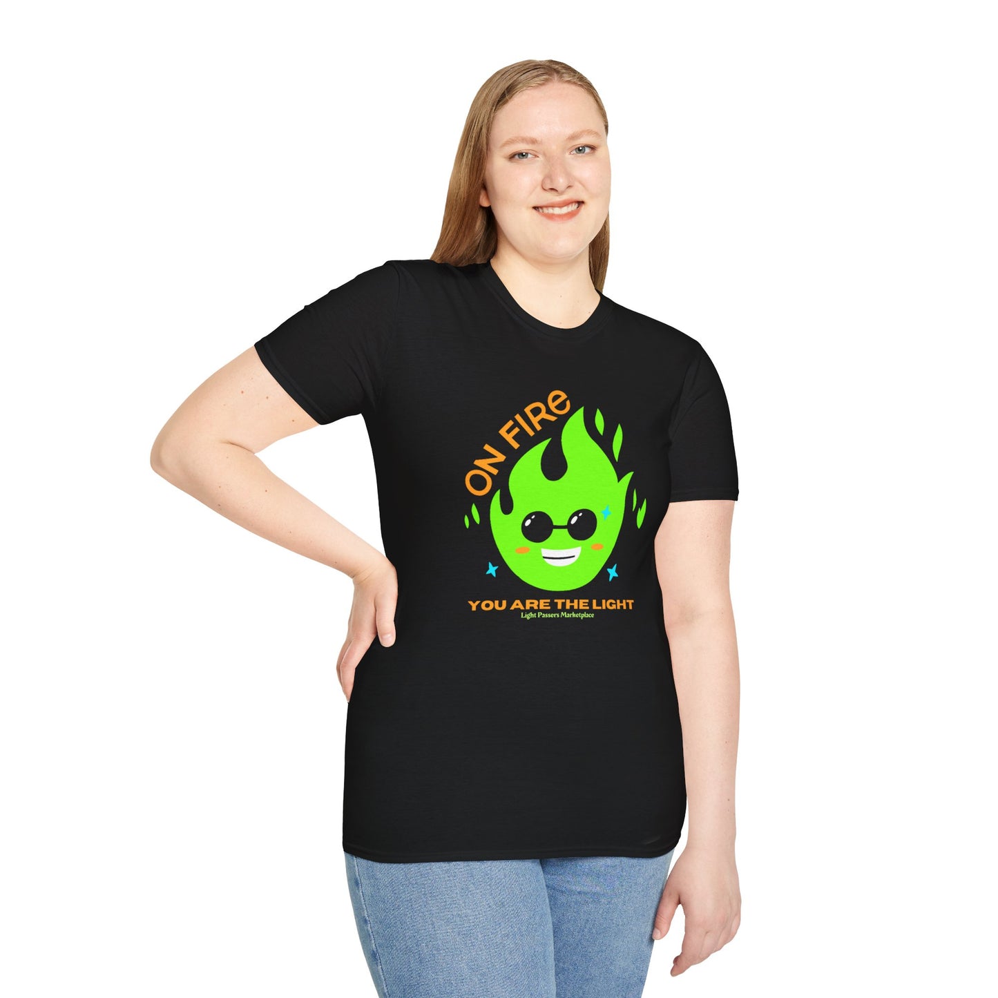 A woman in a black shirt poses, showcasing the On Fire You are the Light Unisex T-Shirt. Soft 100% cotton, twill tape shoulders, no side seams, ribbed collar. Casual comfort with a modern twist.