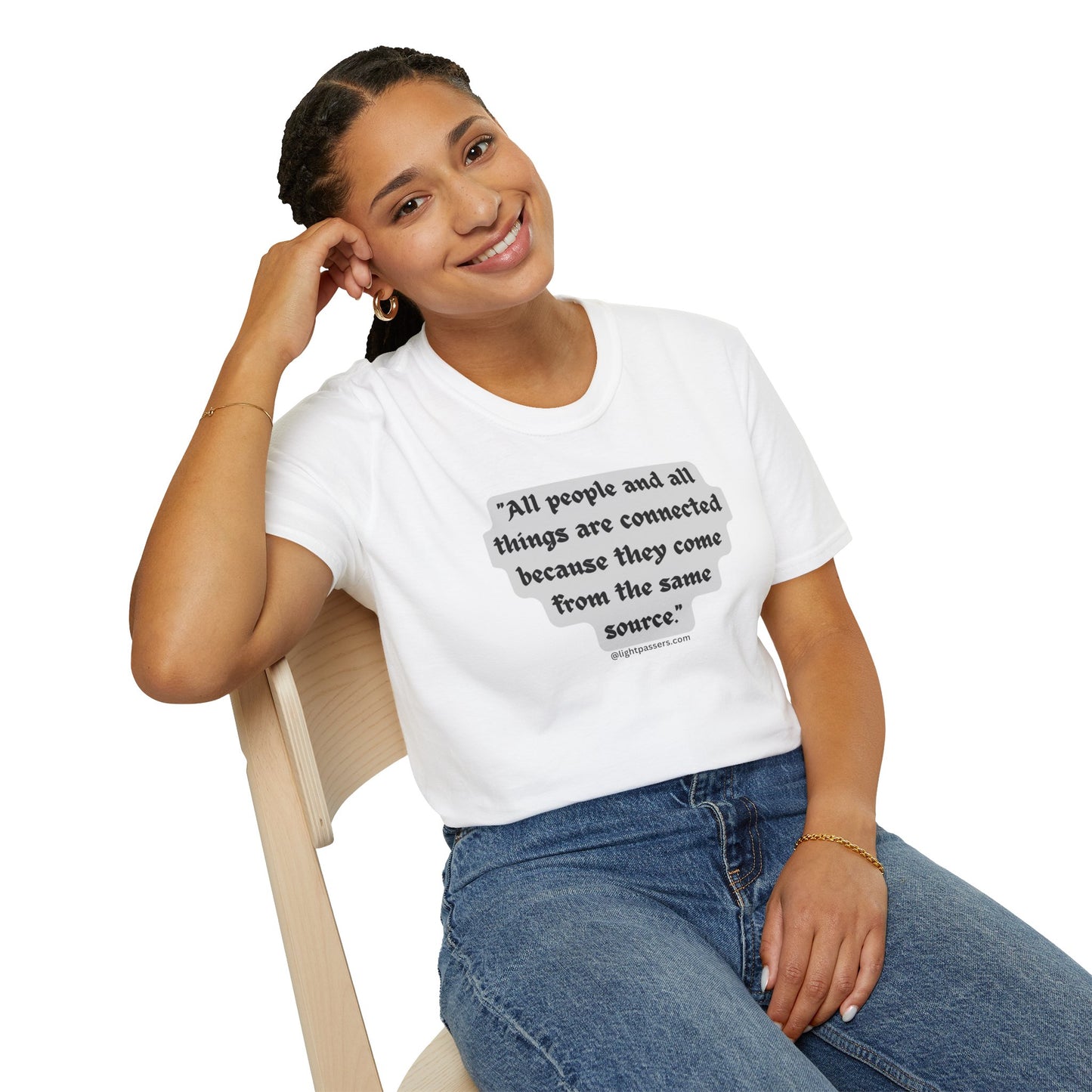 A woman in a white shirt sits on a chair, smiling. A close-up of her face and hand. A gold bracelet on her wrist. Product: All People are Connected Gray Unisex T-shirt.