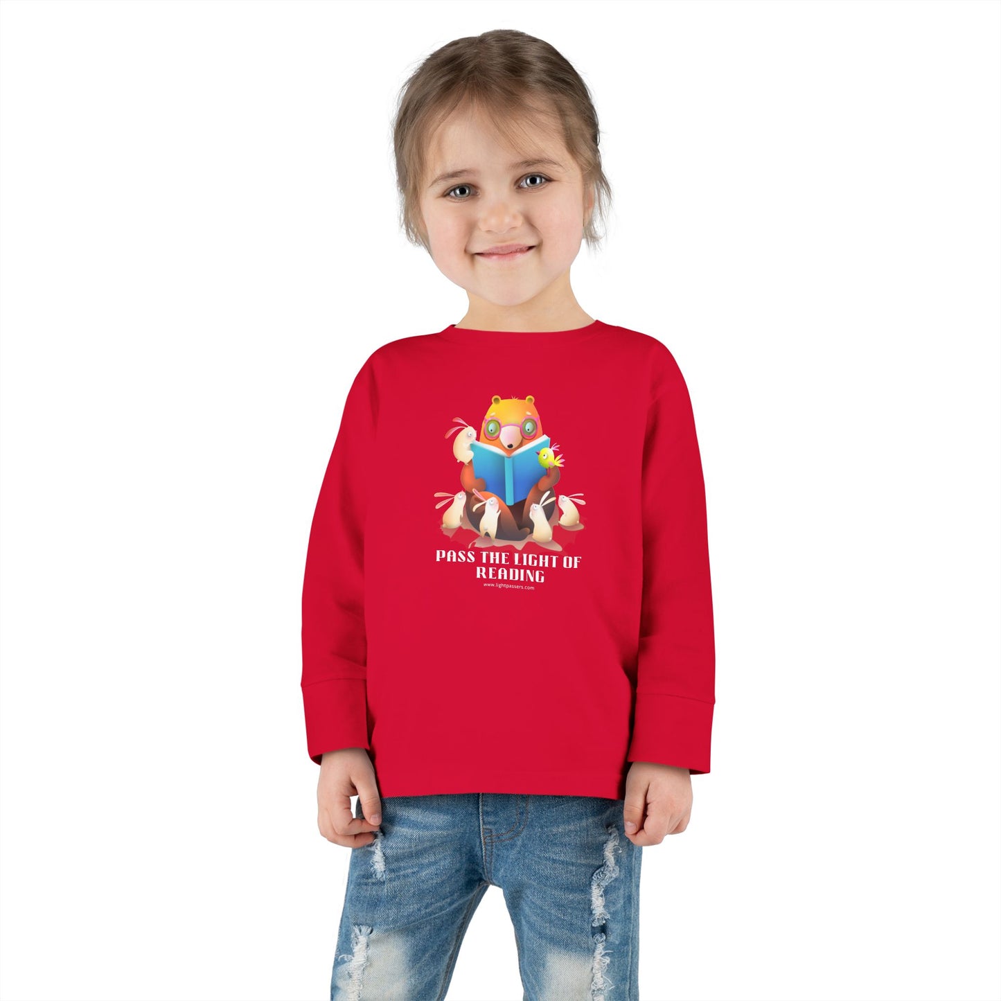 Toddler Long Sleeve Pass the Light of Reading featuring a child in a comfortable, durable 100% cotton jersey tee with topstitched ribbed collar.