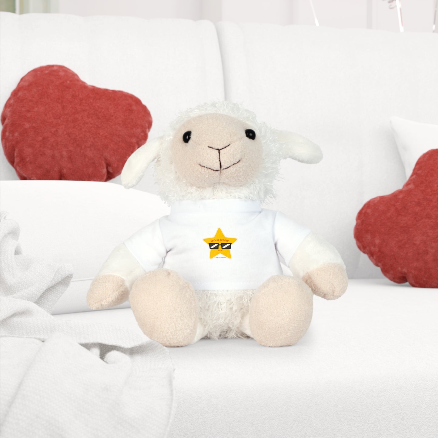Plush Toy with T-Shirt - Star Sheep Reminder; a stuffed animal on a couch, wearing a removable shirt with a Star Sheep design.