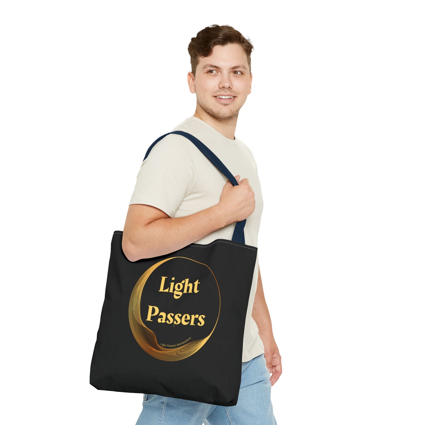 A man carries a Cool Stuff Accessories Light Passers Gold Logo Tote Bag, showcasing its black design and sturdy cotton webbing straps for everyday use.