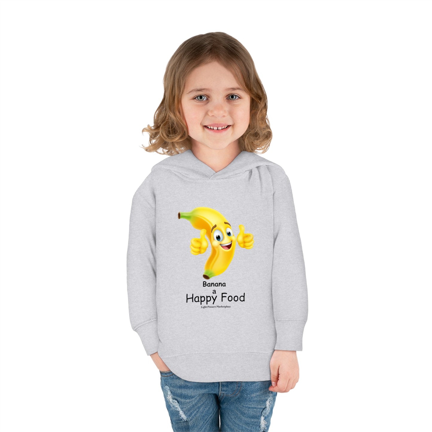 A toddler in a grey Rabbit Skins hoodie with a cheerful cartoon banana design, smiling. Features jersey-lined hood, side-seam pockets, and durable stitching. Cotton-polyester blend for cozy wear.