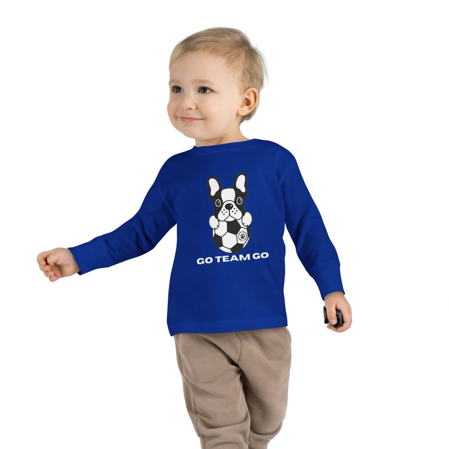 Soccer Dog Toddler Long Sleeve featuring a playful dog and football design, ideal for young sports fans, shown being worn by a child.