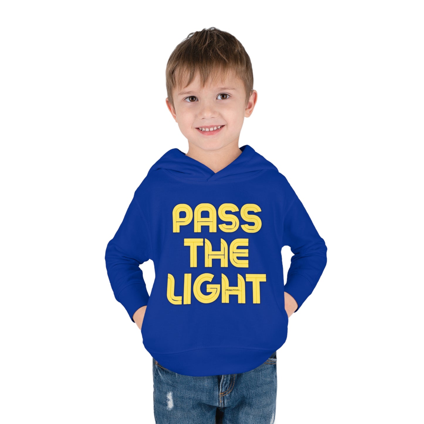 A toddler in a Pass the Light hoodie with side seam pockets, cover-stitched details, and a jersey-lined hood for durability and comfort. Made of 60% cotton, 40% polyester blend.