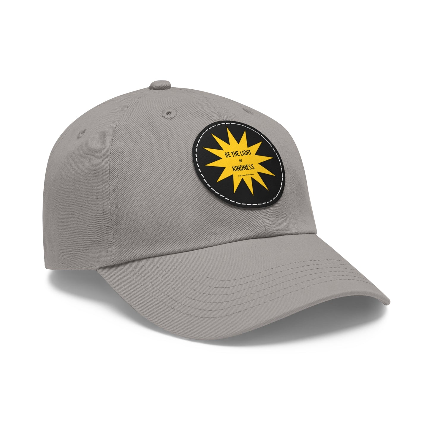 Unisex hat with 'Be the Light of Kindness' yellow sun patch, buckle closure, and durable chino twill fabric, ideal for casual wear or gifting.