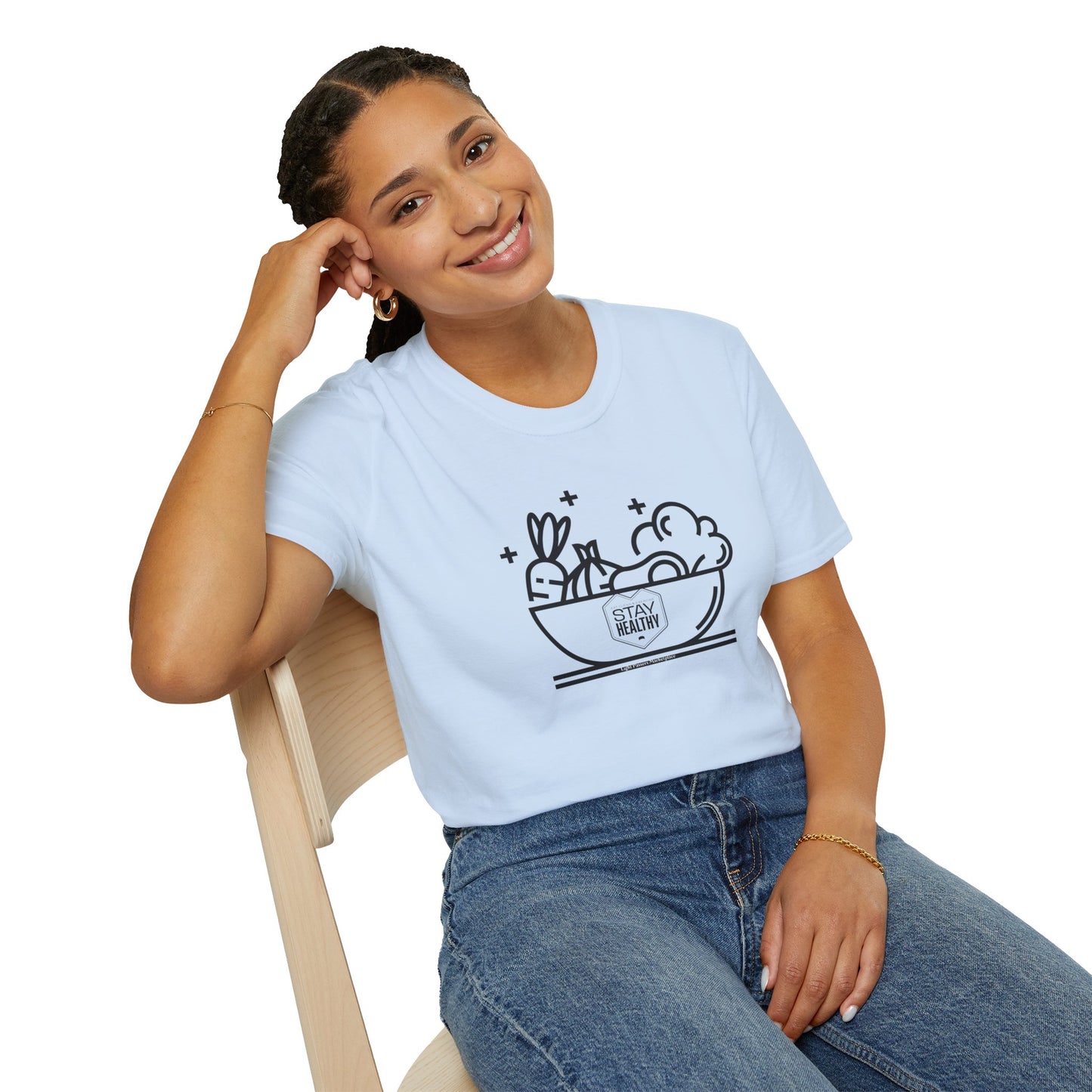 A woman in a white shirt smiles, sitting comfortably on a chair, showcasing the Stay Healthy Unisex T-Shirt's casual comfort and durability.