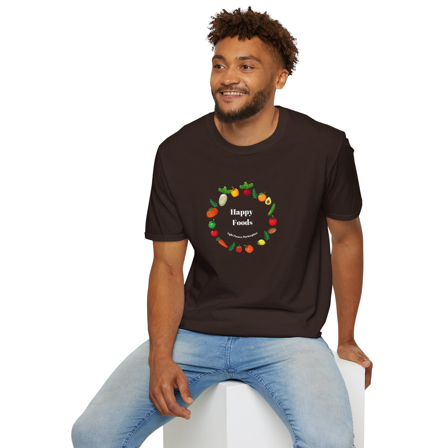 A man in a black logo shirt sits on a cube, showcasing the Happy Foods Ring Unisex T-Shirt. Made of soft 100% cotton, featuring twill tape shoulders and a ribbed collar for durability and comfort.