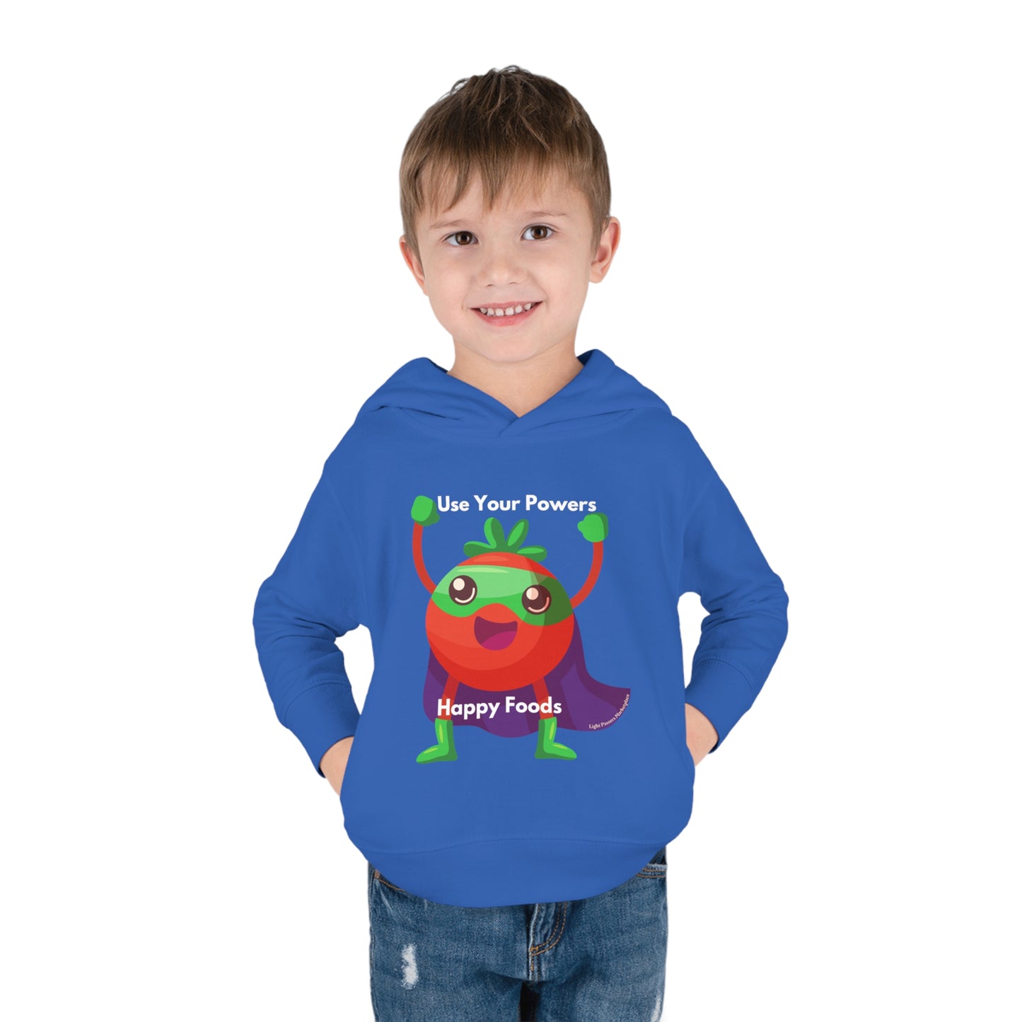 A boy in a Tomato Power Toddler Hoodie with a cartoon character, featuring side-seam pockets and a jersey-lined hood for durability and comfort.