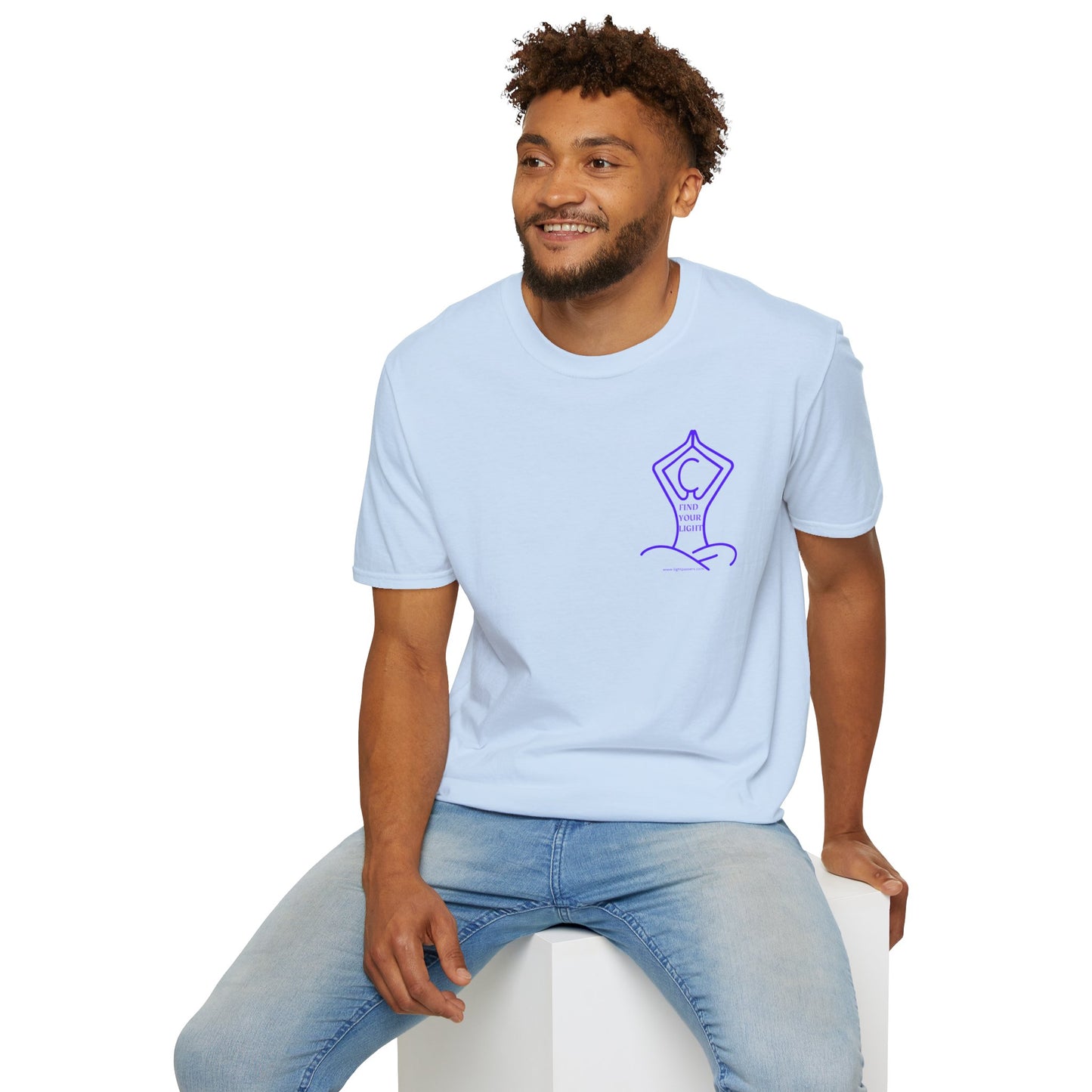 A man in a white shirt sits on a cube, showcasing the Yoga Find Your Light small image Unisex T-Shirt. Soft 100% cotton tee with twill tape shoulders and no side seams for durability and comfort.