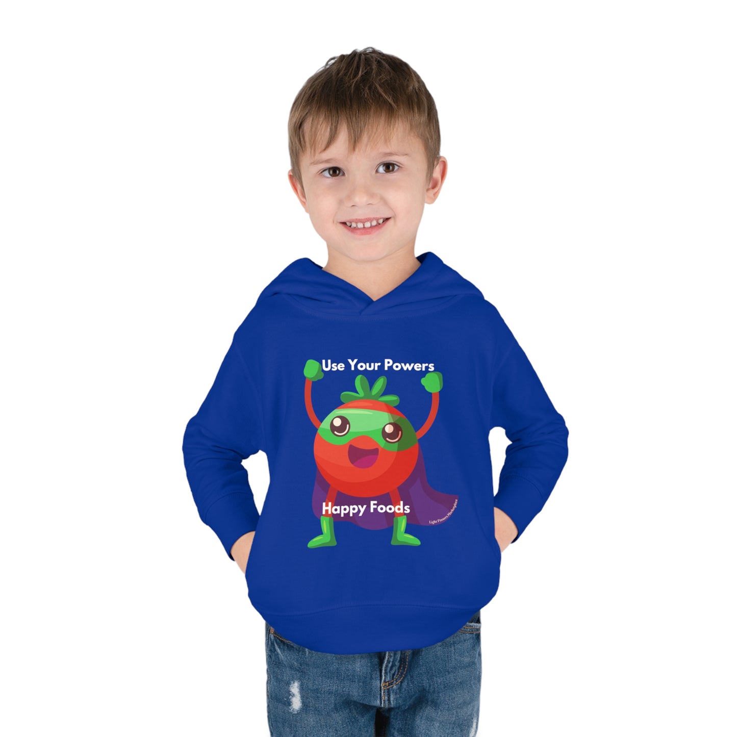 A toddler in a blue hoodie with a cartoon tomato superhero design, showcasing cover-stitched details, side seam pockets, and a jersey-lined hood for durability and comfort.