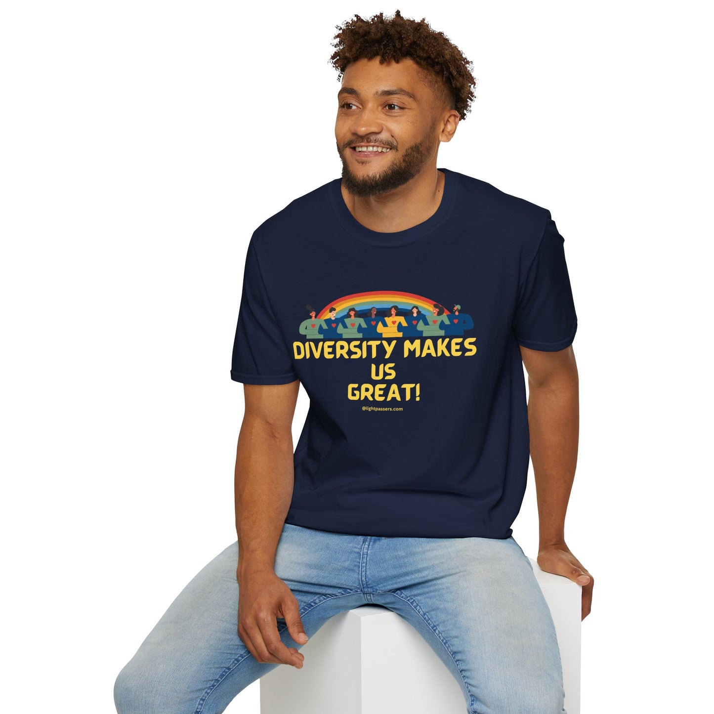 A man in a blue shirt sits on a cube, showcasing a unisex heavy cotton tee. The tee features smooth fabric for vivid printing, no side seams, and shoulder tape for durability.