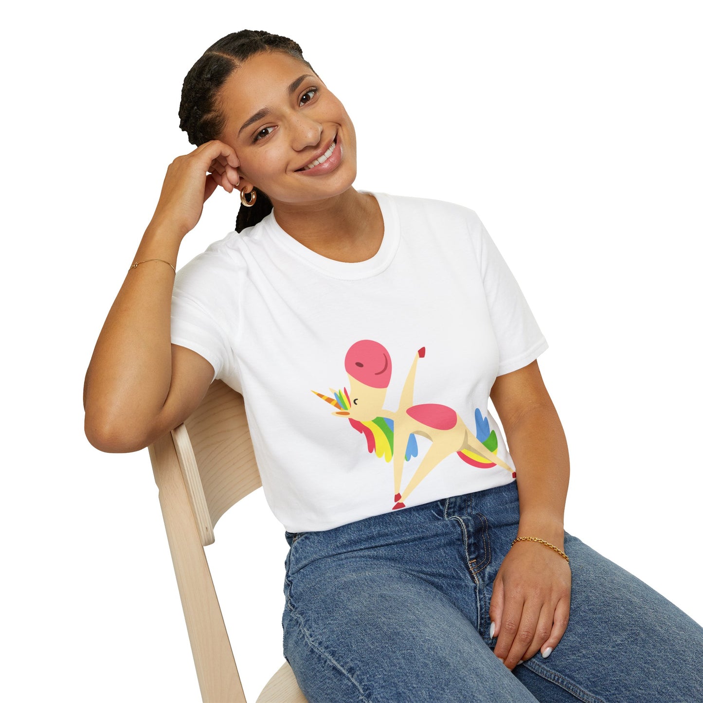 A woman in a Unicorn Stretch Yoga Unisex T-Shirt, sitting on a chair, smiling. The shirt features a unicorn design on soft 100% cotton fabric with twill tape shoulders for durability. No side seams for comfort.