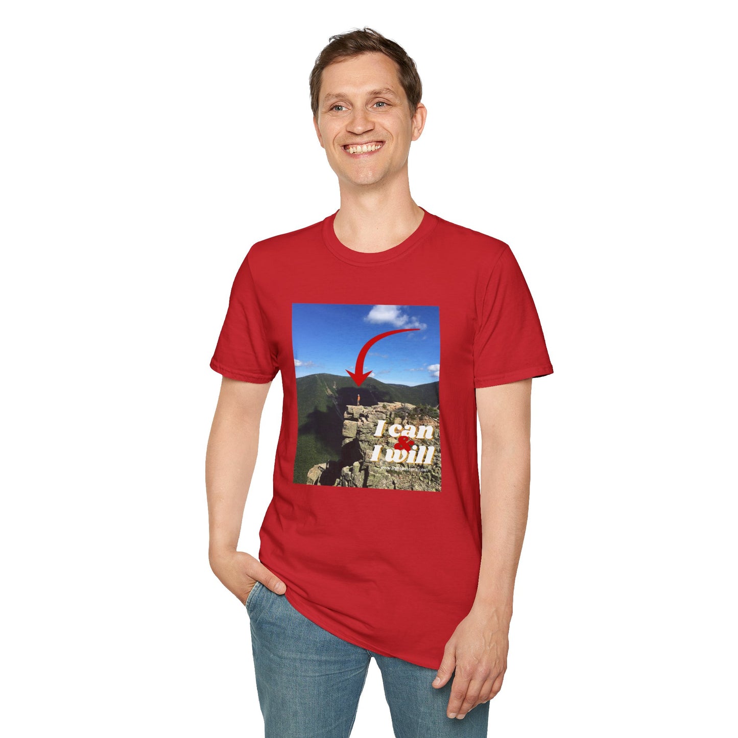 A person in a red hiking t-shirt standing confidently on a cliff. Unisex soft-style tee made with 100% ring-spun cotton, featuring twill tape shoulders and a ribbed collar. Ethically sourced and Oeko-Tex certified.