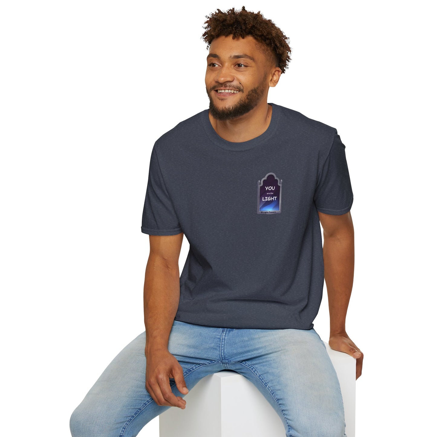 A man in a white cube tee, smiling, showcasing the YOU ARE THE LIGHT small Mirror Unisex T-shirt. Casual, heavy cotton, tear-away label, classic fit.