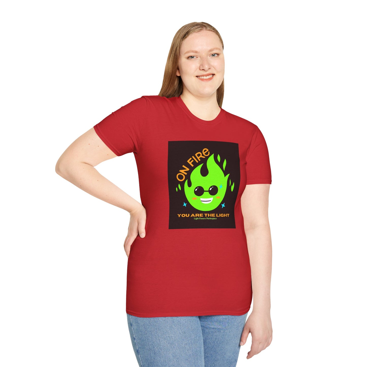 A woman in a red shirt with a green flame and sunglasses poses for a picture, showcasing the On Fire You are the Light Unisex T-Shirt. Made of soft 100% cotton with twill tape shoulders for durability.