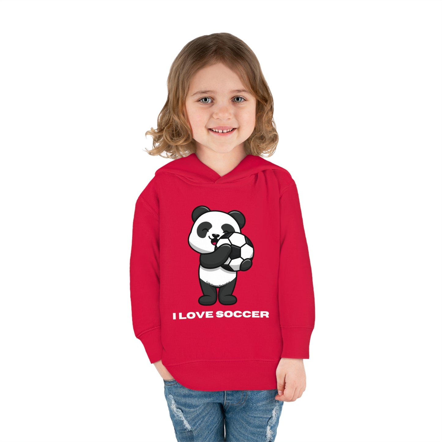 Toddler hoodie with a girl smiling, featuring a panda holding a football ball design. Jersey-lined hood, cover-stitched details, and side seam pockets for comfort and durability. Ideal for soccer fans.