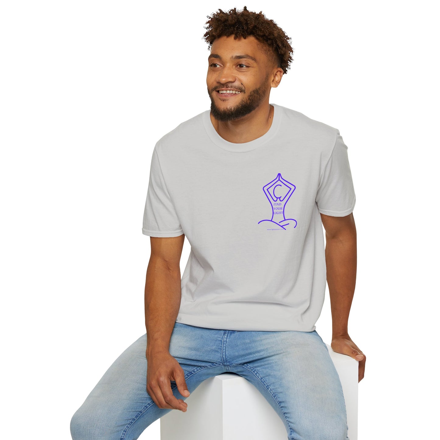 A man in a white shirt sitting on a cube, embodying casual comfort in the Yoga Find Your Light Unisex T-Shirt. Soft 100% cotton, twill tape shoulders, no side seams, ribbed collar.