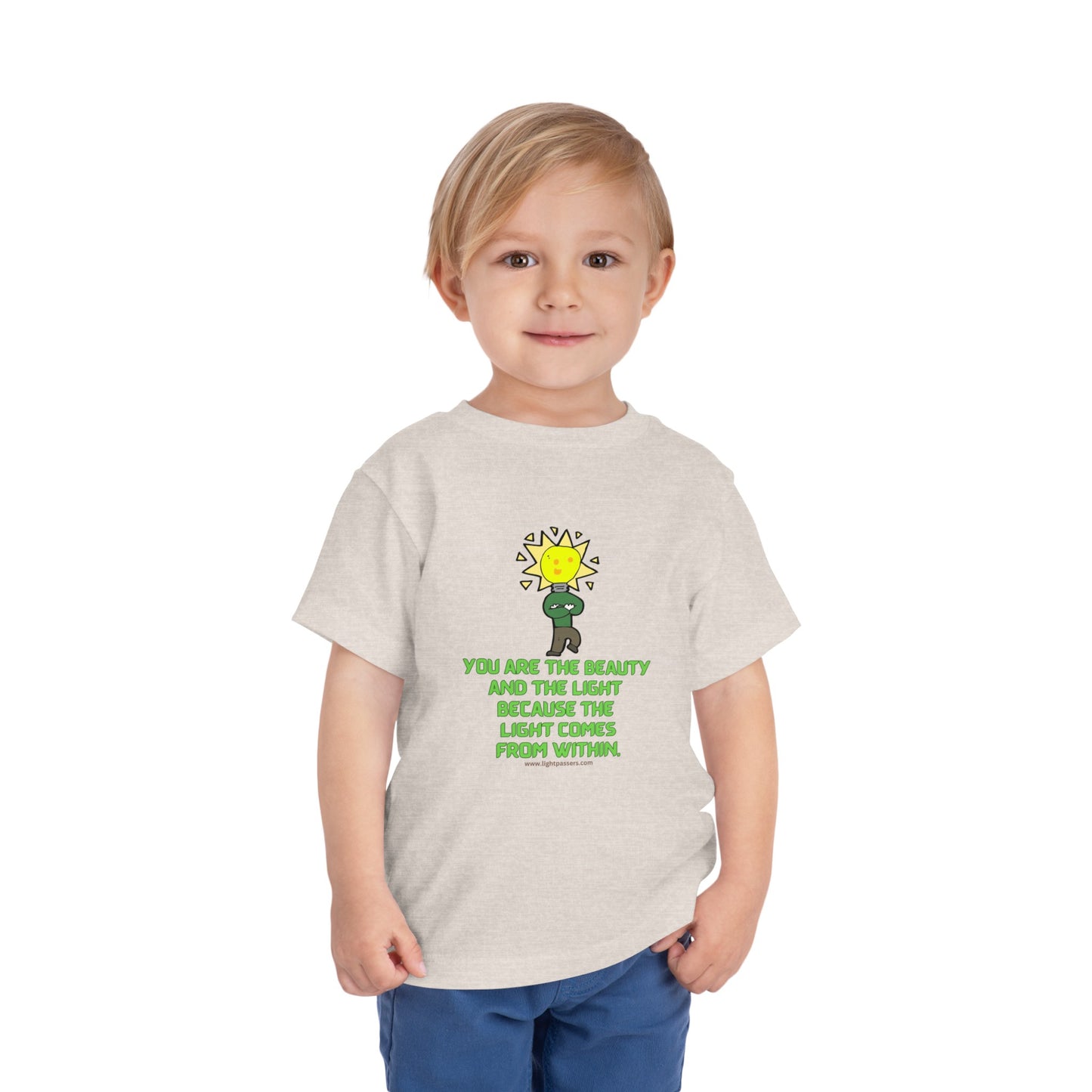A toddler wearing a white Beauty and the Light custom t-shirt. Features include 100% Airlume combed cotton, tear-away label, and lightweight fabric. Ideal for everyday wear.