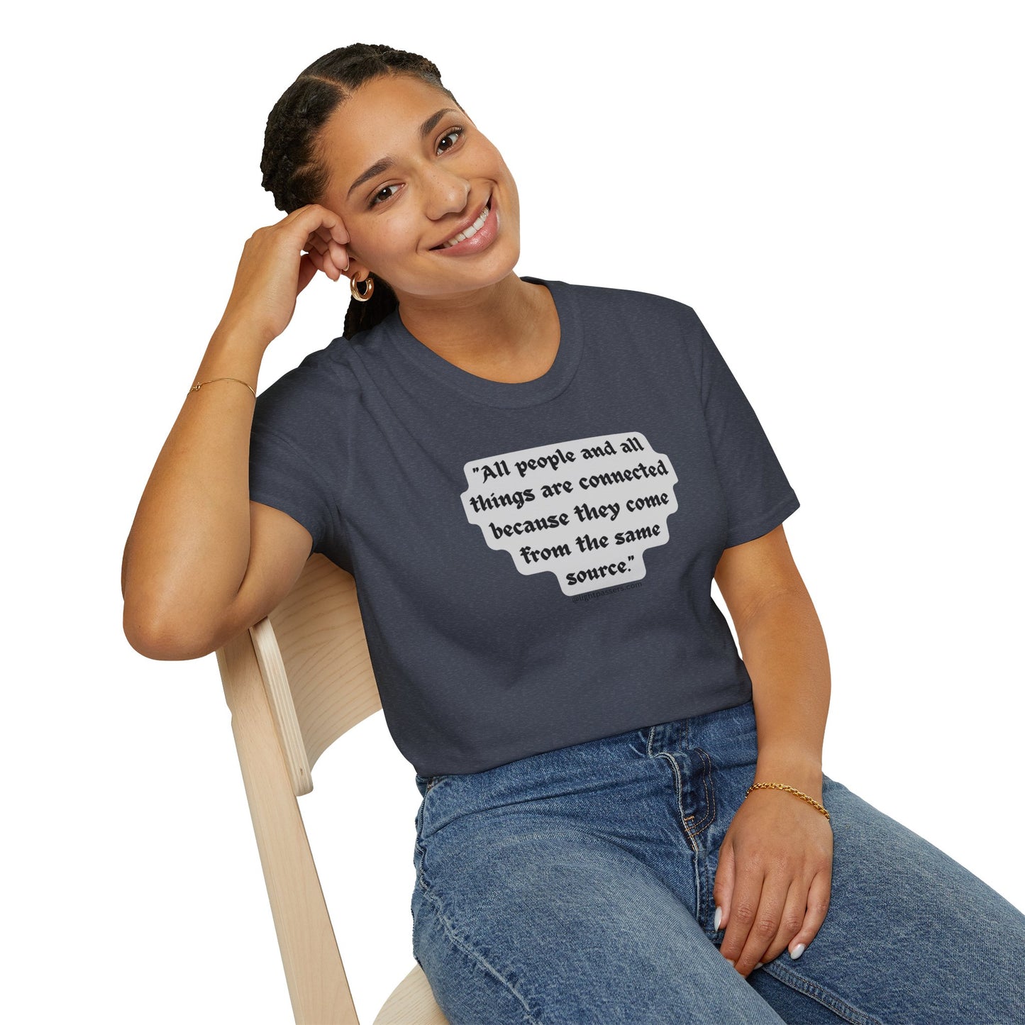 A smiling woman in a gray shirt with a white text quote sits on a chair, showcasing the All People are Connected Gray Unisex T-shirt. Classic fit, 100% cotton tee with smooth surface for vivid printing.