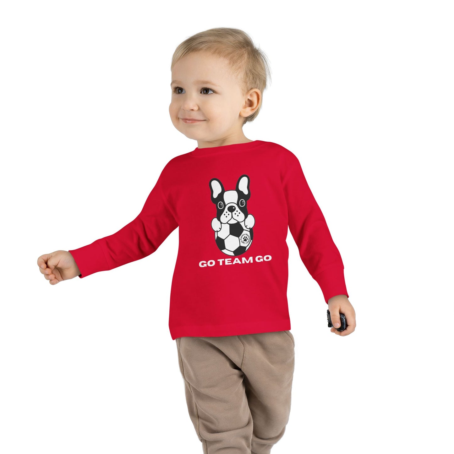 Soccer Dog Toddler Long Sleeve features a playful dog with a football, ideal for young sports enthusiasts, emphasizing comfort with its structured fit and ribbed cuffs.