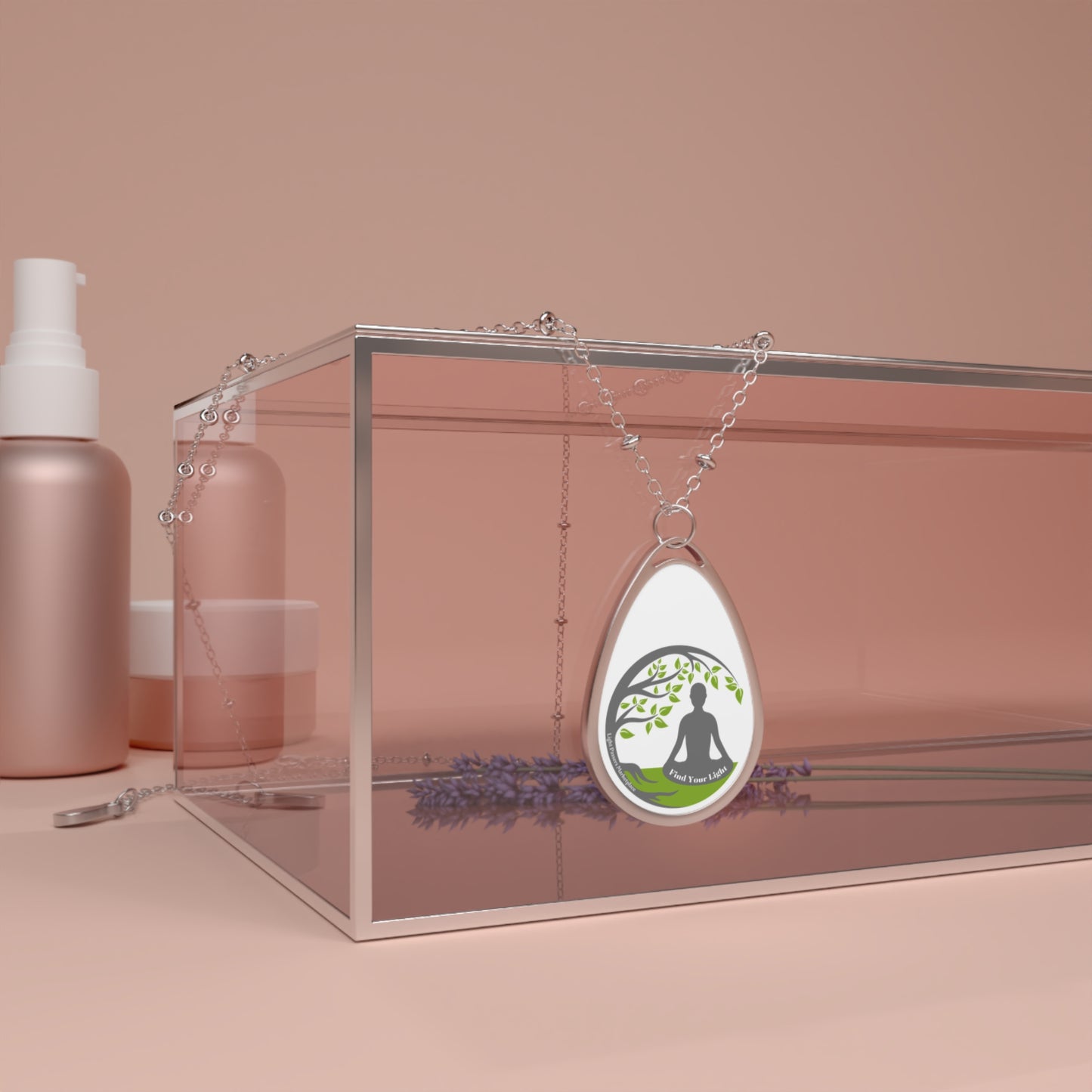 Silver chained necklace with oval pendant, displayed in a glass box alongside a lavender flower, ideal for personalized and unique DIY fashion accessories.