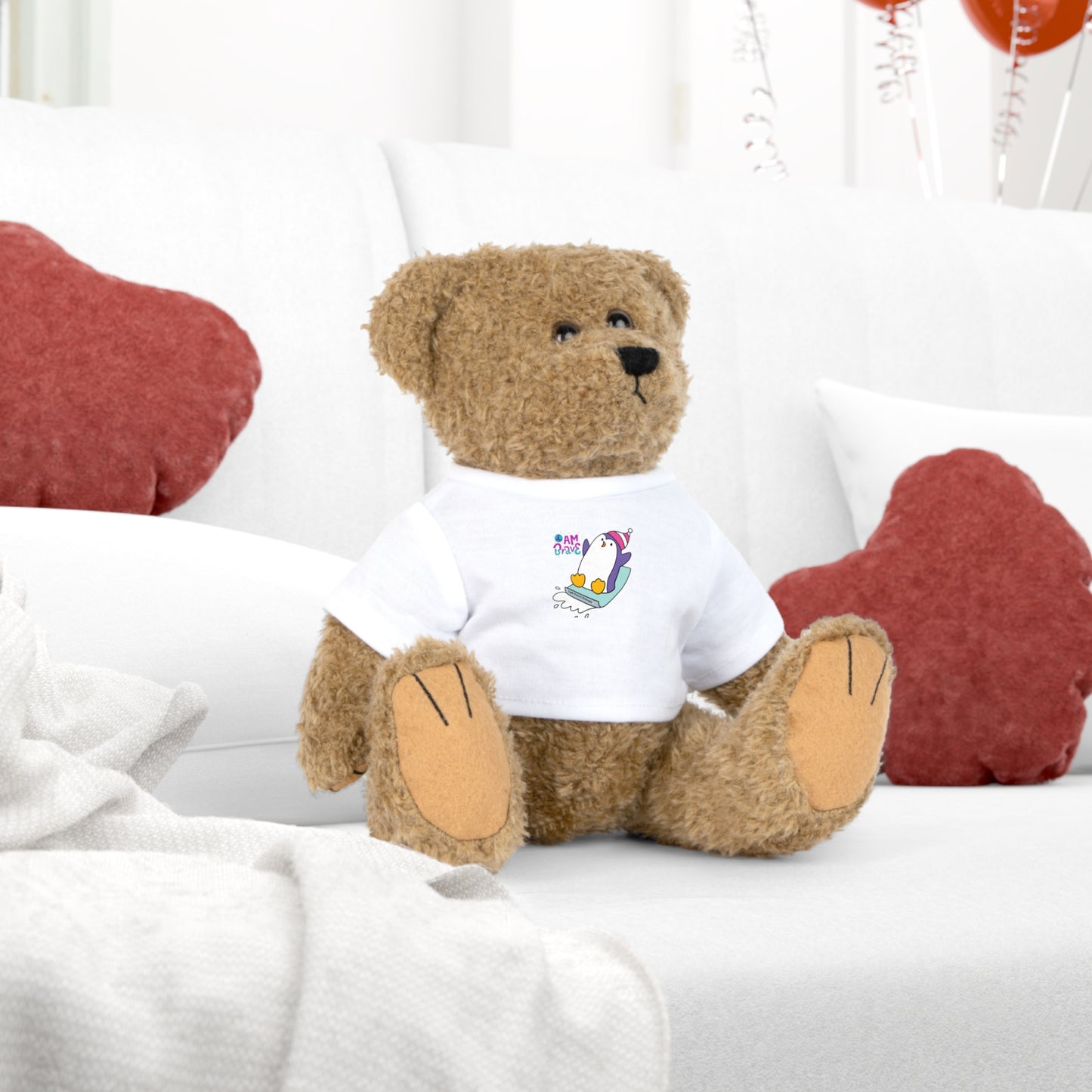 Teddy bear with removable white t-shirt featuring 'I am Brave' Penguin design, part of Cool Stuff Stuffies collection. Ideal for comfort and encouragement.