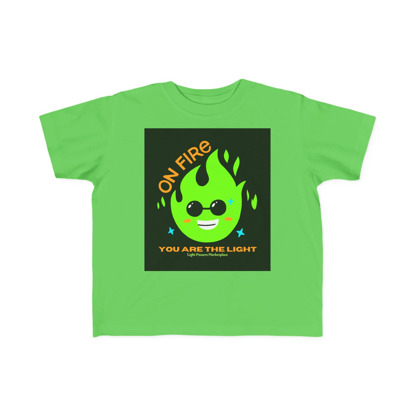 A toddler's tee featuring a green shirt with a cartoon face and a black square with orange text. Made of 100% combed, ring-spun cotton, light fabric, and a tear-away label.