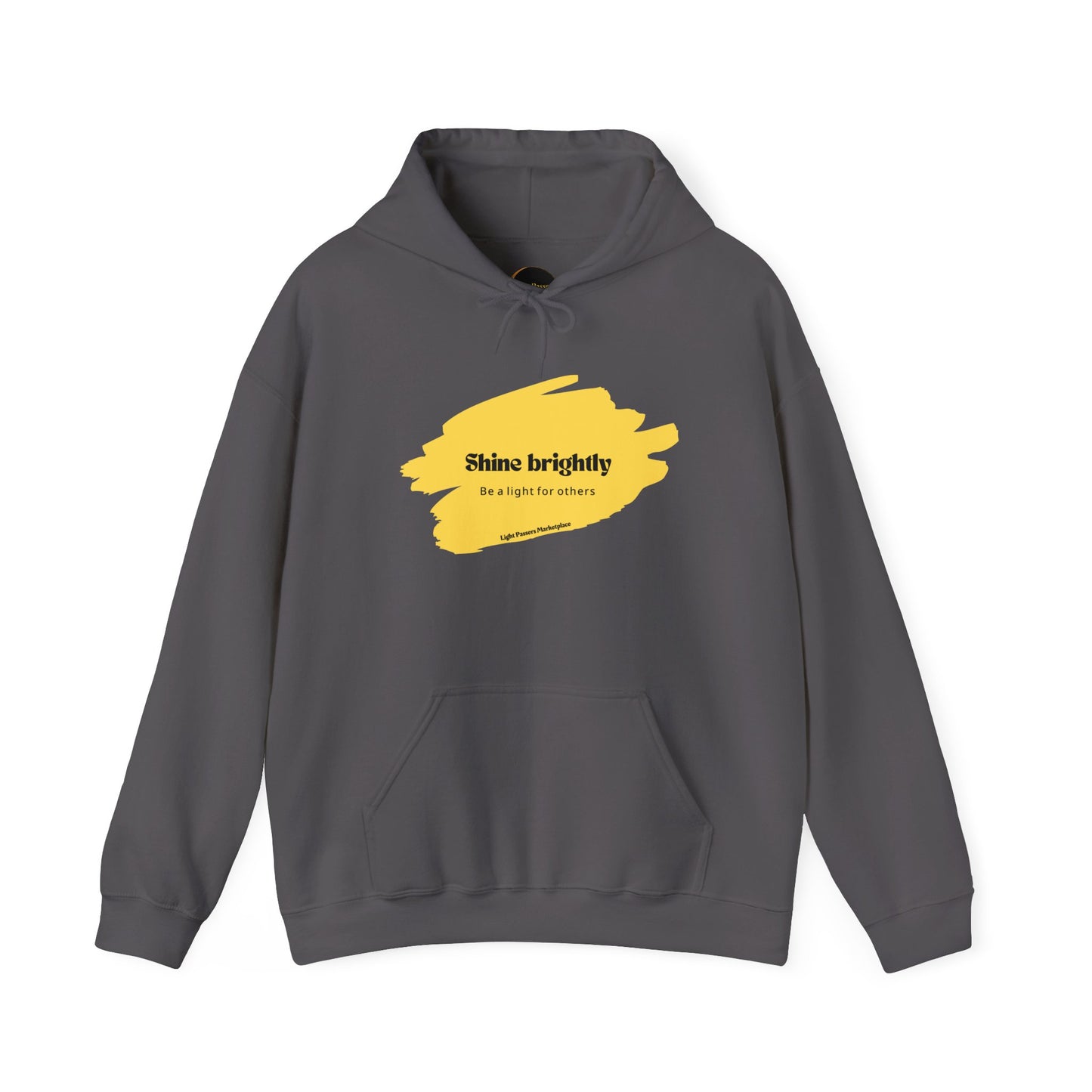 The Light Inspirational Hoodie - Shine Brightly Adult Unisex Heavy Blend™ Sweatshirt featuring yellow paint design and a cozy kangaroo pocket.