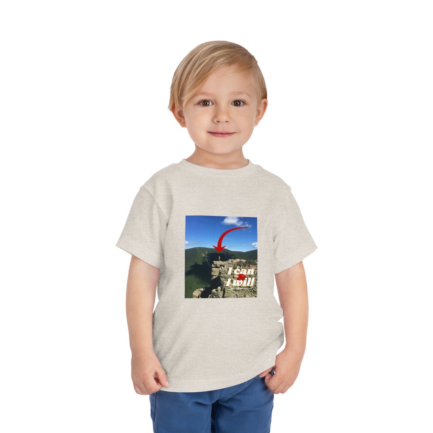 Toddler in white I Can and I Will t-shirt, standing on a cliff. Bella Canvas tee, 100% cotton, tear-away label, 3.9 oz fabric.