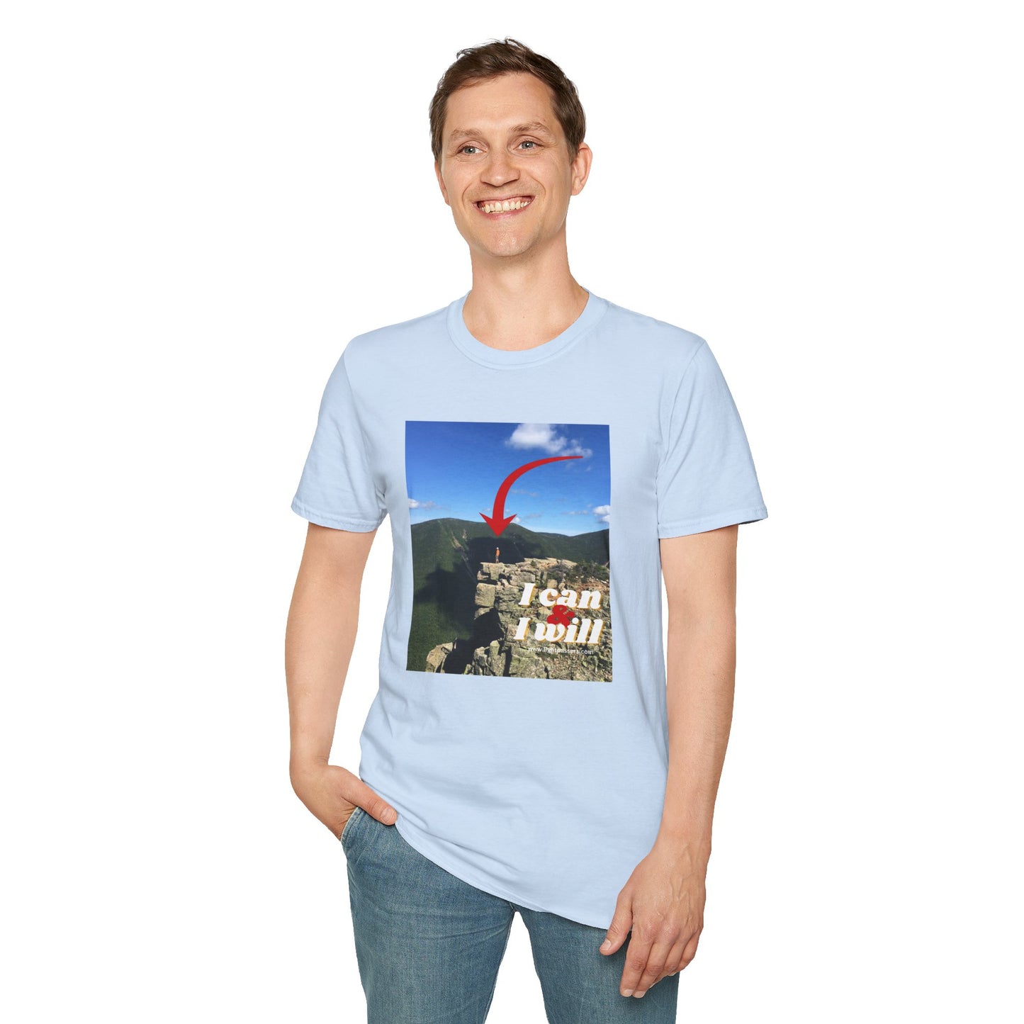A person in a Hiking I Can and I will unisex t-shirt, standing confidently on a cliff. Made of soft 100% cotton, with twill tape shoulders for durability and a ribbed collar.