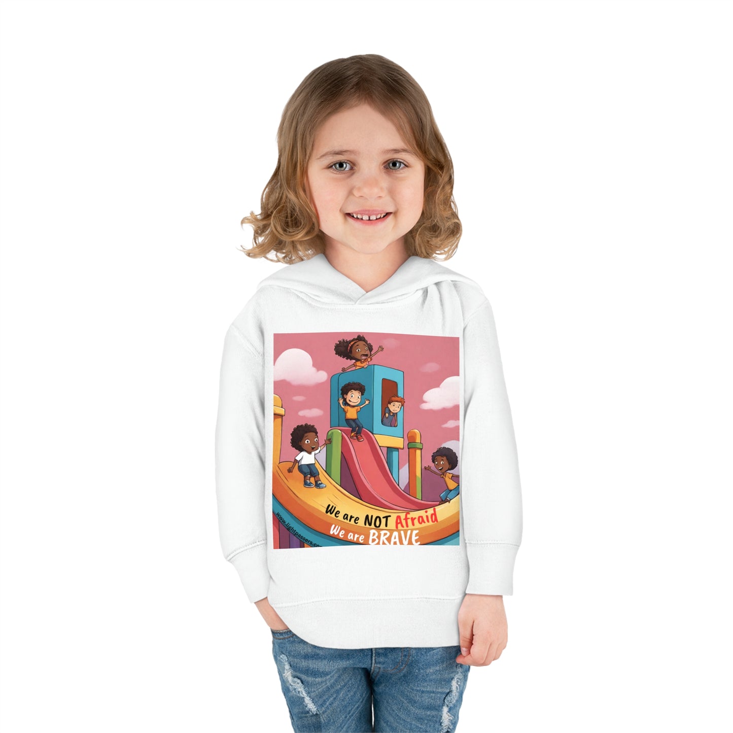 A smiling child in a white hoodie, featuring a Rabbit Skins toddler hoodie with jersey-lined hood, cover-stitched details, side seam pockets, and durable fabric blend for cozy wear.