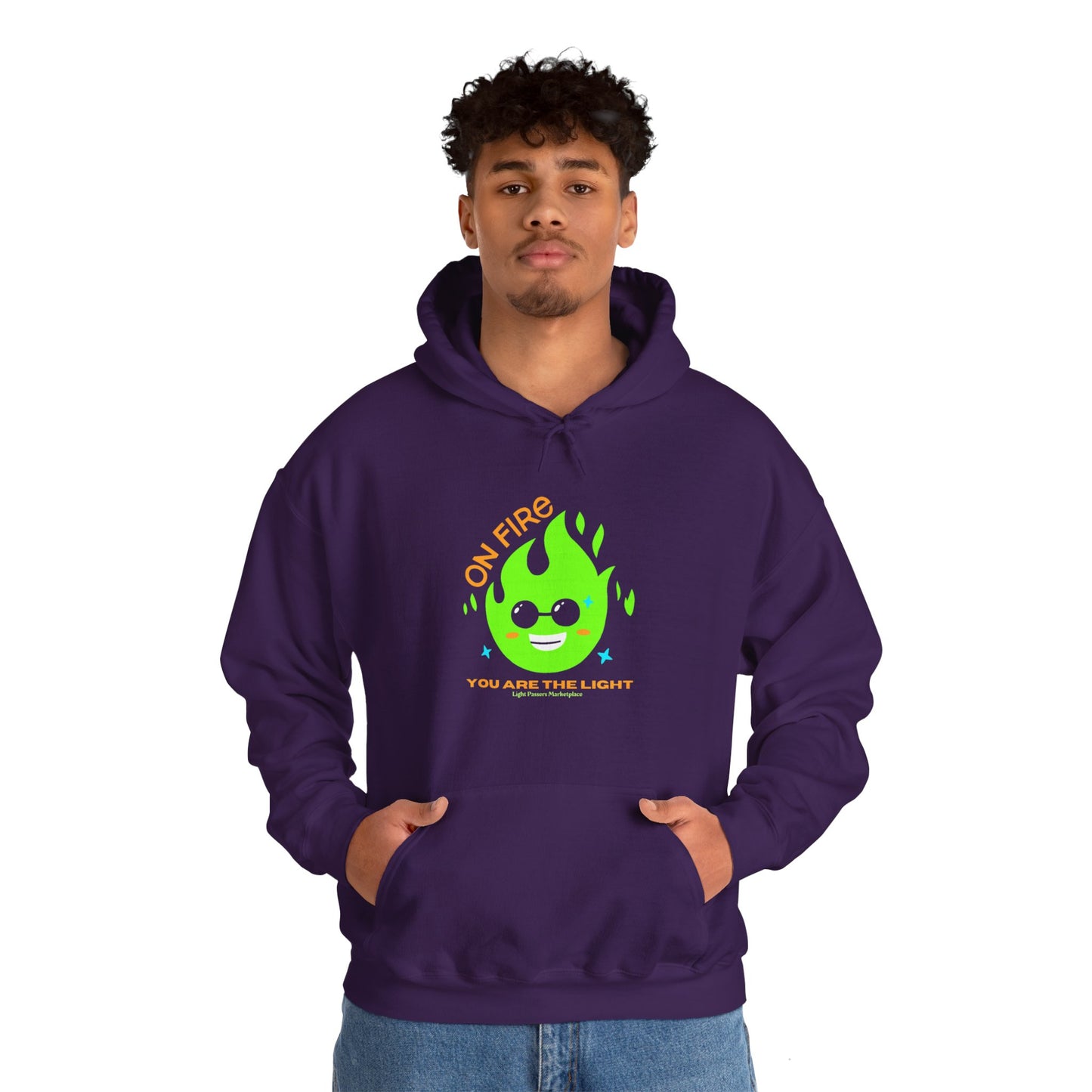 A purple hoodie featuring a green flame design and yellow text, worn by a man with curly hair and a goatee. Made of 50% cotton and 50% polyester, this cozy unisex hooded sweatshirt is perfect for chilly days.