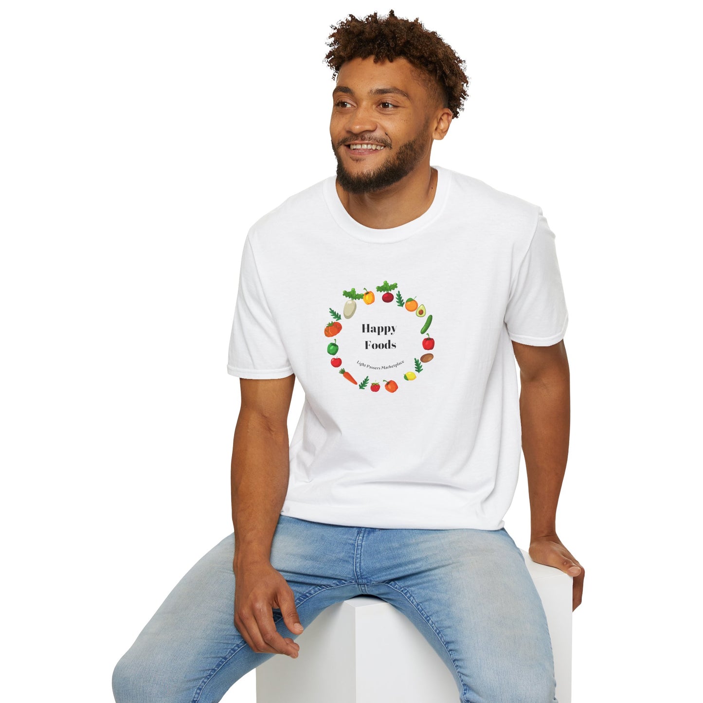 A man in a white logo shirt sits on a cube, showcasing the Happy Foods Ring Unisex T-Shirt. The image features a casual, soft 100% cotton tee with twill tape shoulders and a ribbed collar.