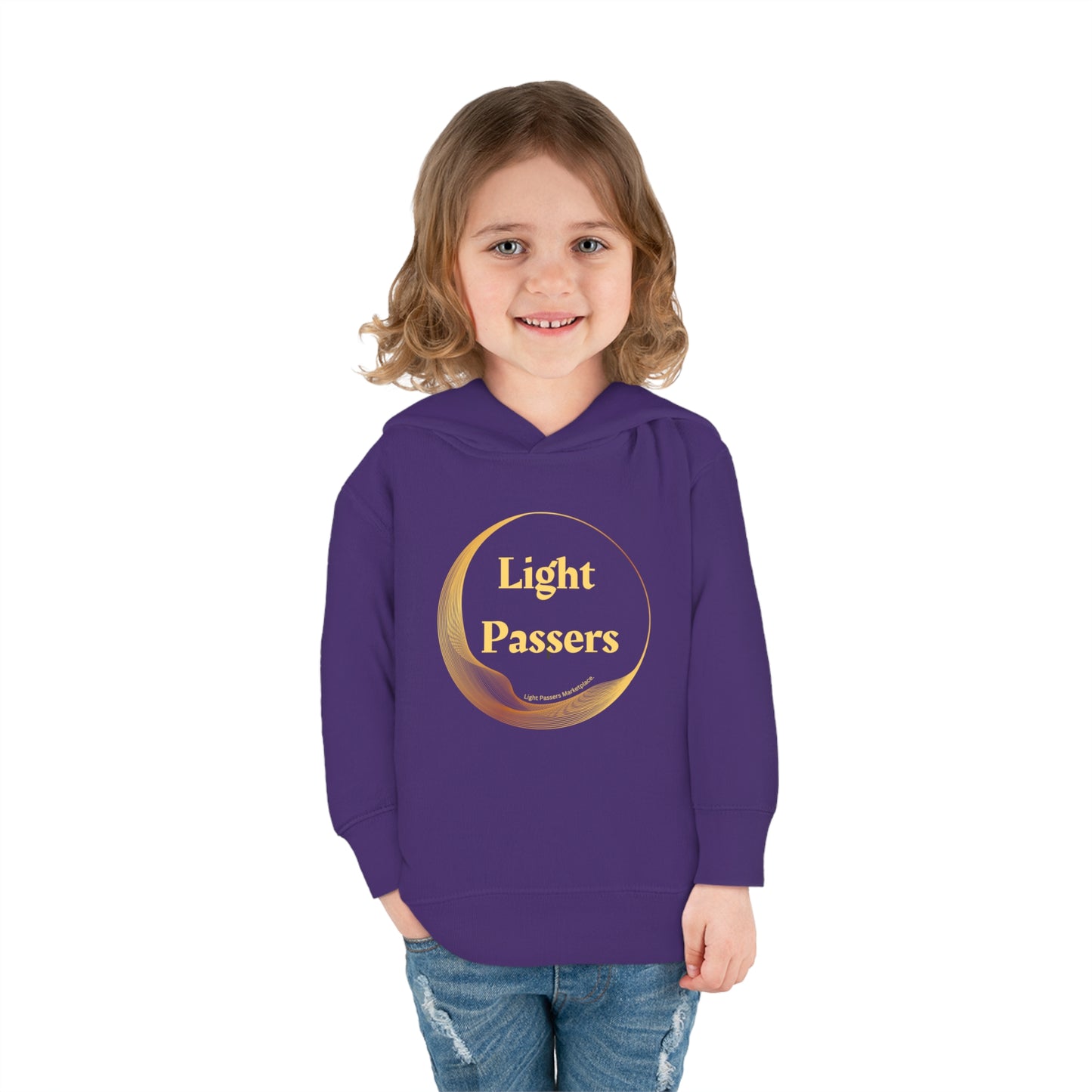 A child in a purple sweatshirt smiles, showcasing the Light Passers Logo Toddler Hoodie Sweatshirt. Features jersey-lined hood, cover-stitched details, and side seam pockets for durable comfort.