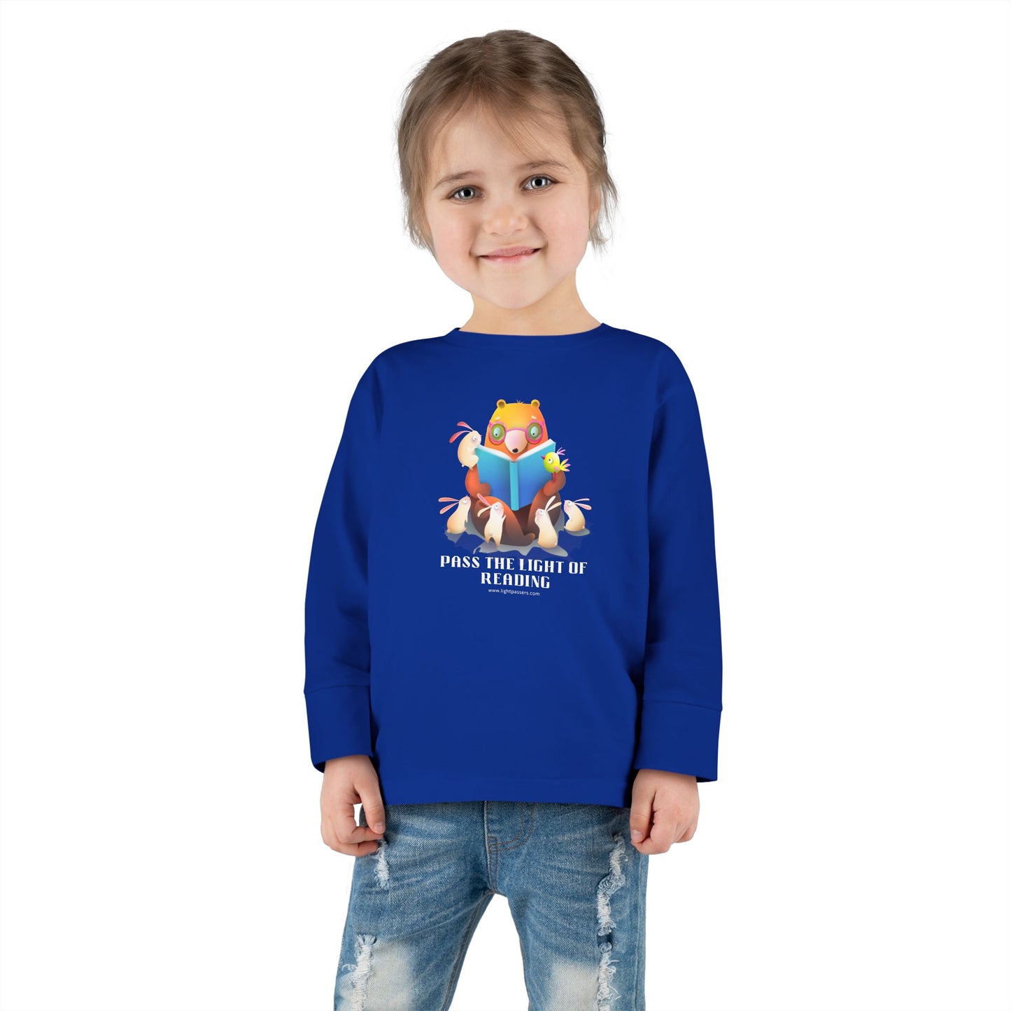 Toddler Long Sleeve Pass the Light of Reading tee featuring a cartoon bear reading with bunnies, highlighting comfort and durability with topstitched collar and tear away label.