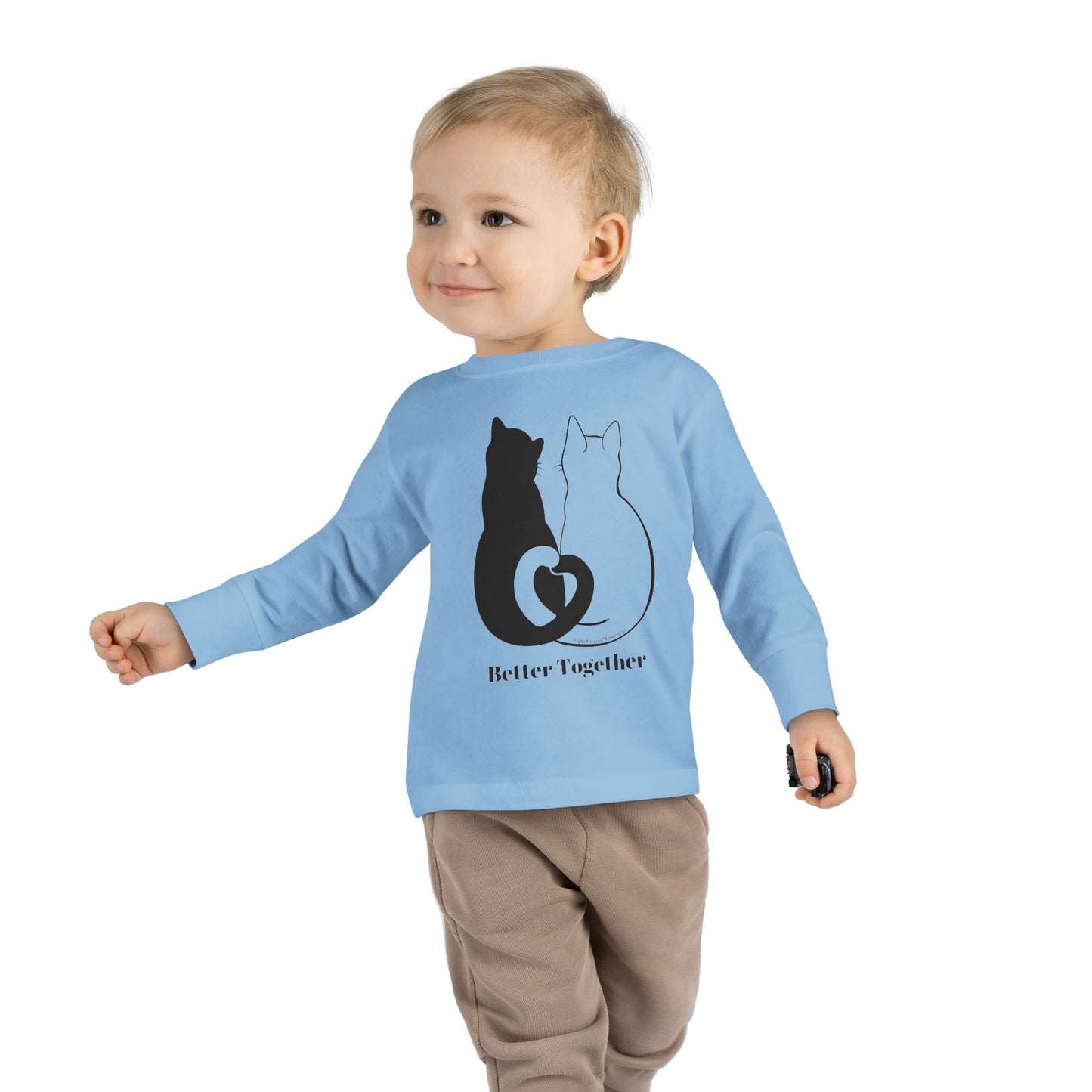 Toddler wearing a Better Together Cat Love Tails Long Sleeve Tee, featuring a cat design. Made from 100% combed ringspun cotton for comfort and durability.