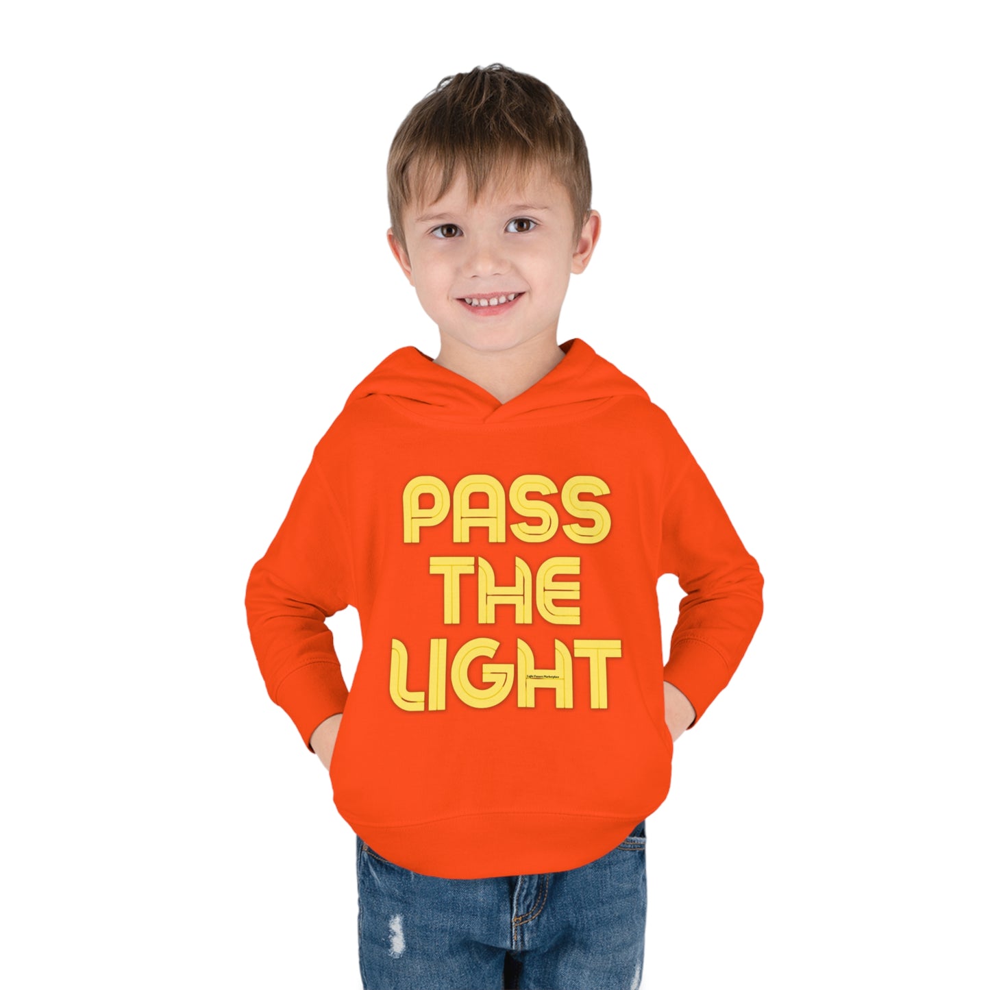 A boy in a Pass the Light Toddler Hooded Sweatshirt, smiling with glasses, showcasing jersey-lined hood, cover-stitched details, and side seam pockets for durable coziness.